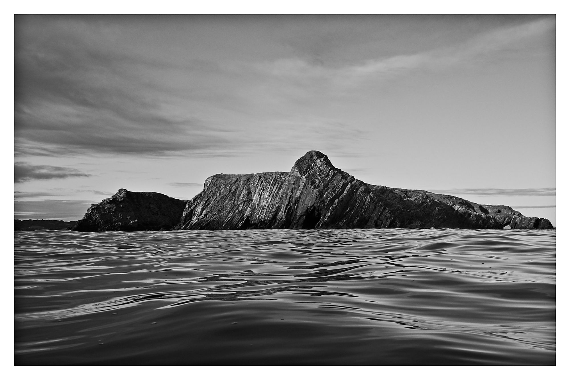 The western end of Horse Island ‘sits’ on the  rolling swell as the tide recedes into the evening.