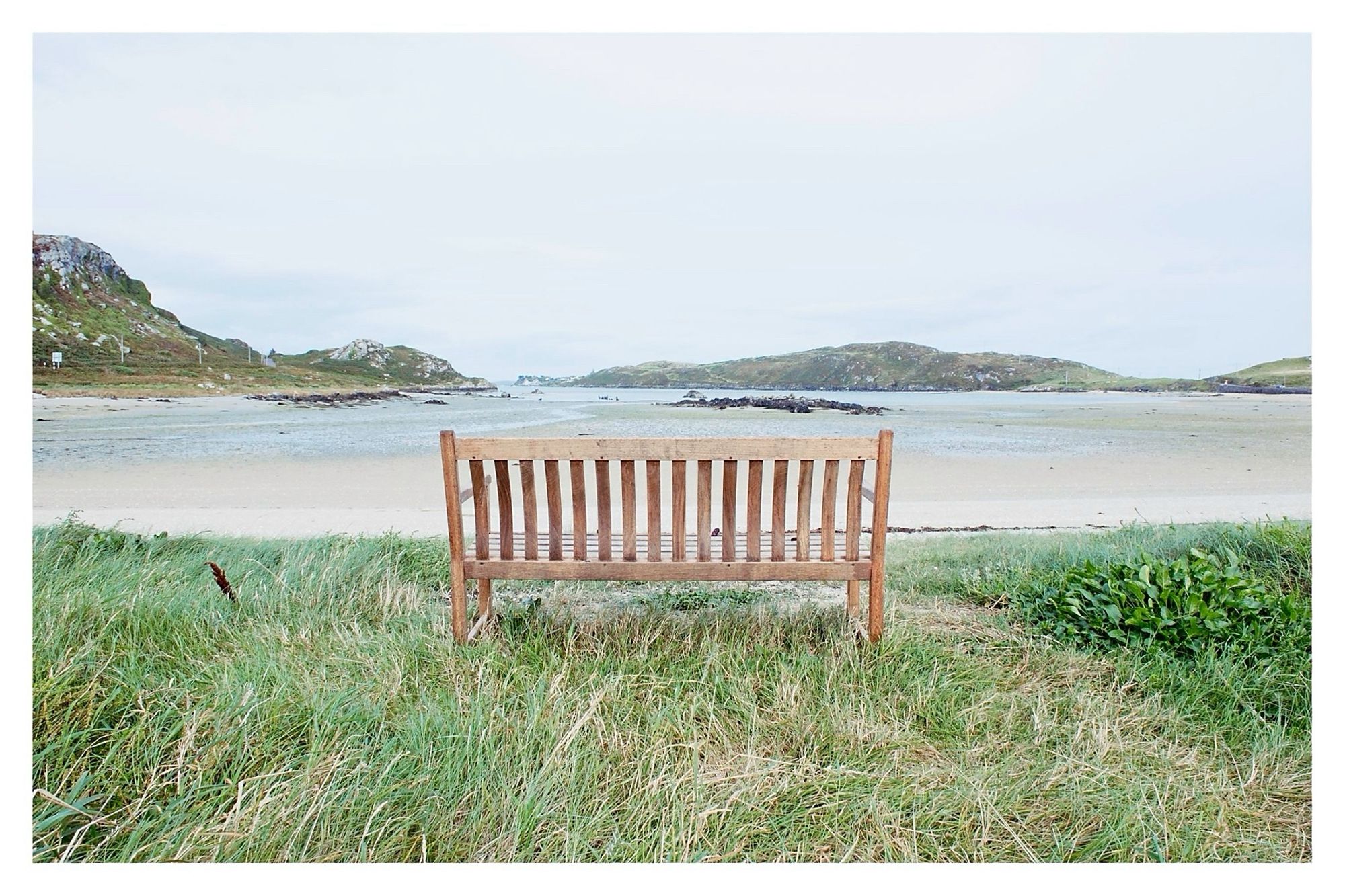 A wooden bench above the tide line looks out towards Crookhaven.