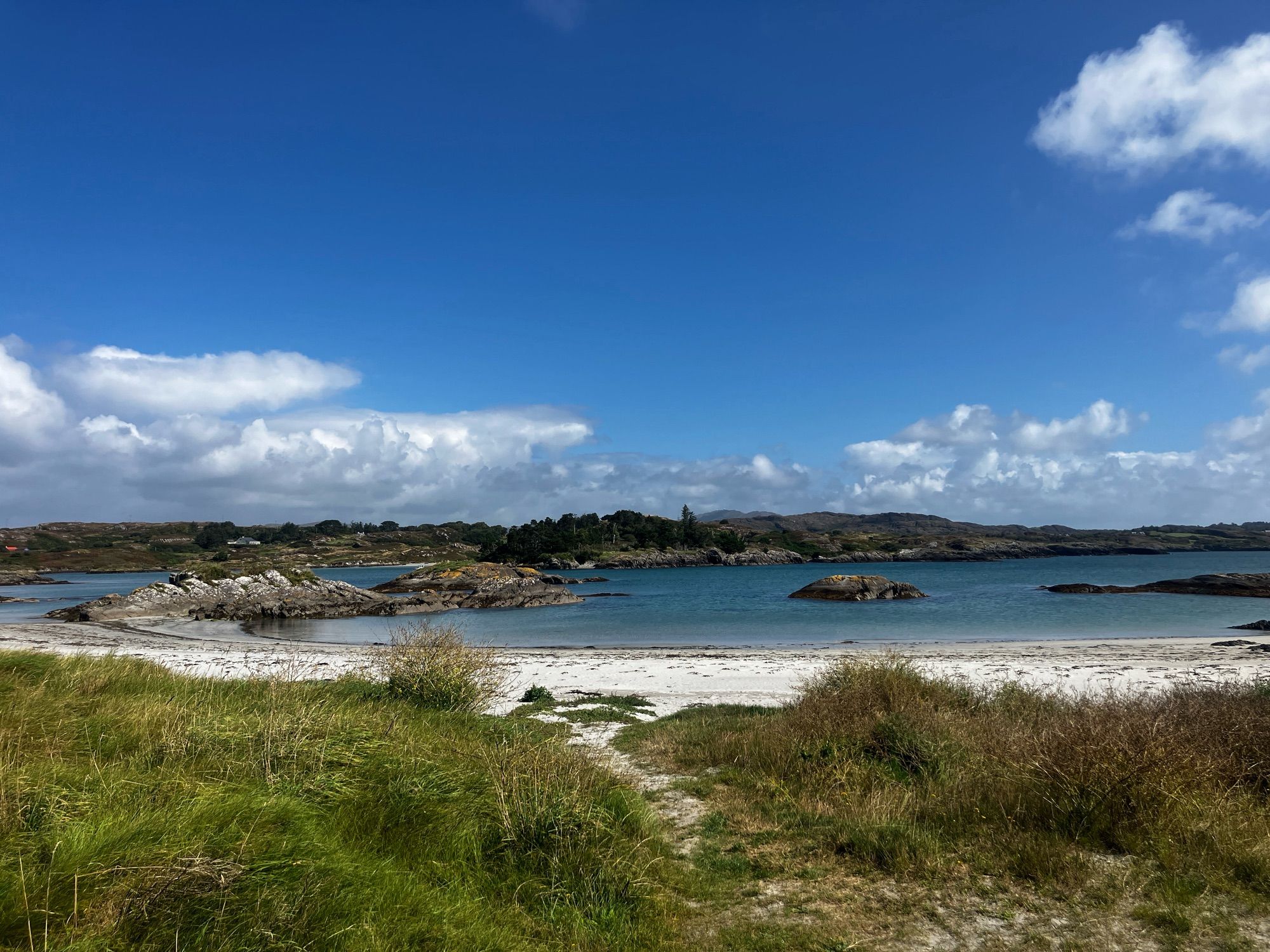 Ballyrisode beach looking back east with Mount Gabriel in the distance. 

A shallow inlet popular with families.