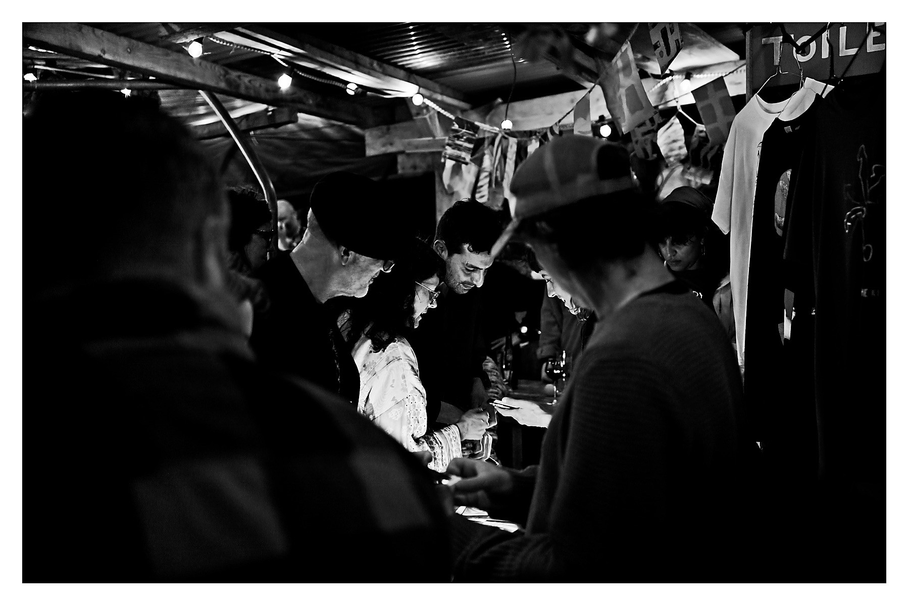 A crowd around the merch stand with Liadan and Taff in the centre making their pick of goodies.