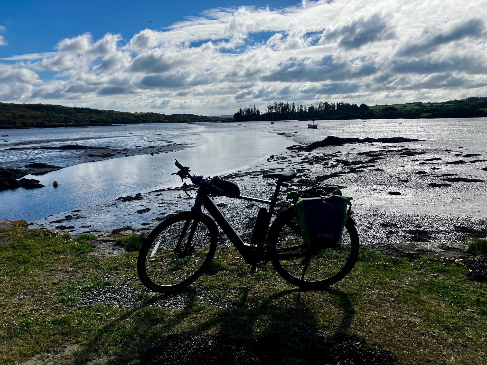 My bike on a pier with the estuary behind. It’s low tide.

The sun is out but a still a little cloudy. 

About 8 km cycle ahead to start.