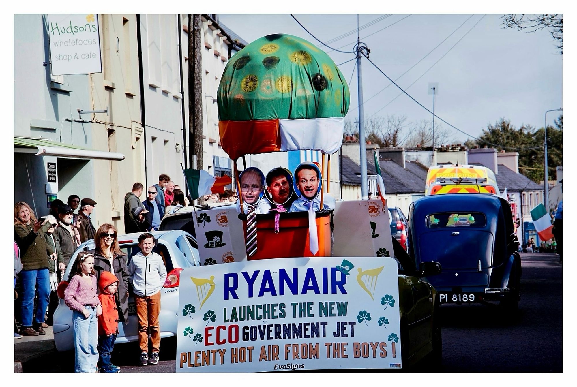 St Patrick’s day parade float. Mock hot air balloon with the coalition, Micheál, Eamonn & Leo, government’s heads, with ties peeping out of the balloon basket. 

Sign below them reads:
“RyanAir launches new eco government jet. Plenty hot air from the boys!’