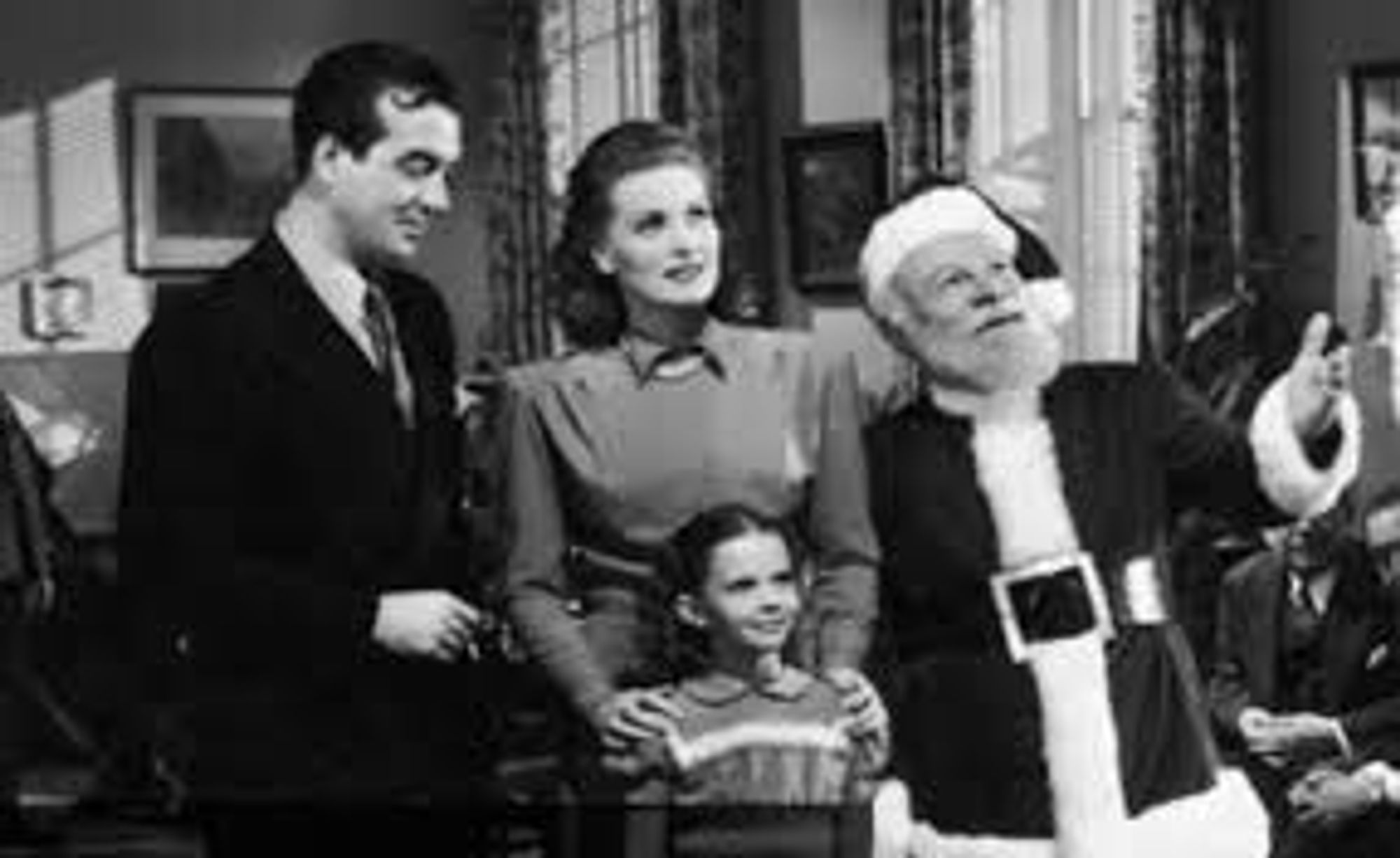 Maureen O’Hara with John Payne, Ed Gwynn as Kris Kringle, and a young Natalie Wood before the Christmas Tree in the 1947 seasonal classic Miracle on 34th Street. 

Reportedly, Ed Gwynn so convinced Natalie Wood that he was Santa Claus that it wasn’t until the wrap party and she saw him in his street clothes that she learned he wasn’t the Jolly Old Elf. 