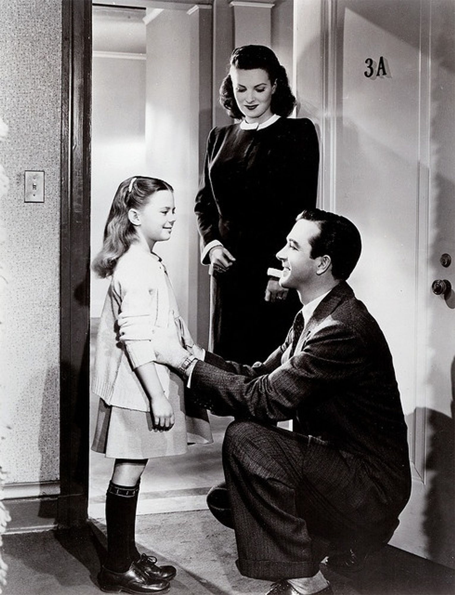 Maureen O’Hara standing behind young Natalie Wood and a crouching John Payne from the seasonal classic Miracle on 34th Street. 