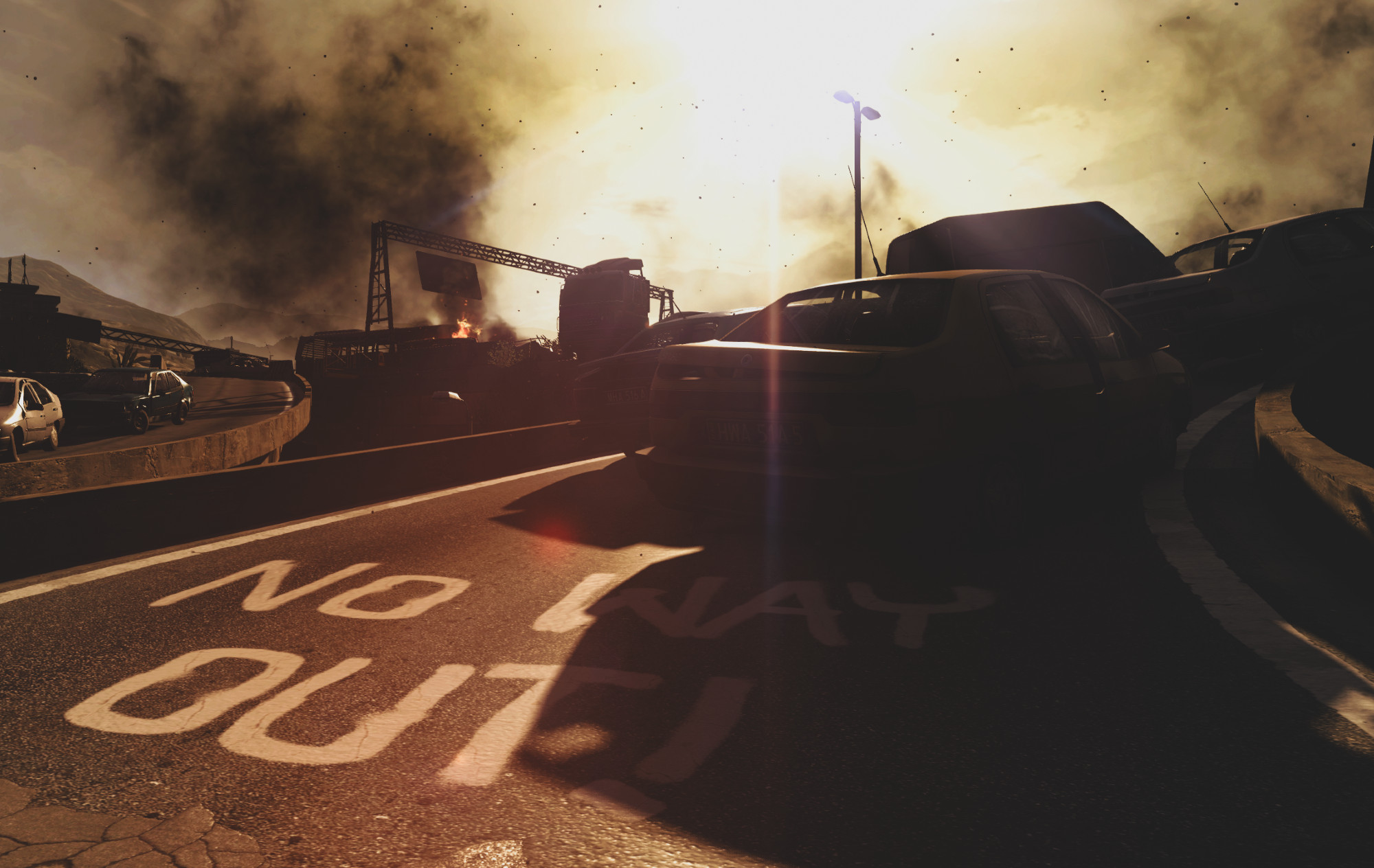 A screenshot out of the game Dying Light; abandoned cars are piled up on an overpass with smoke billowing into the sky behind them. No Way Out! is painted on the asphalt.