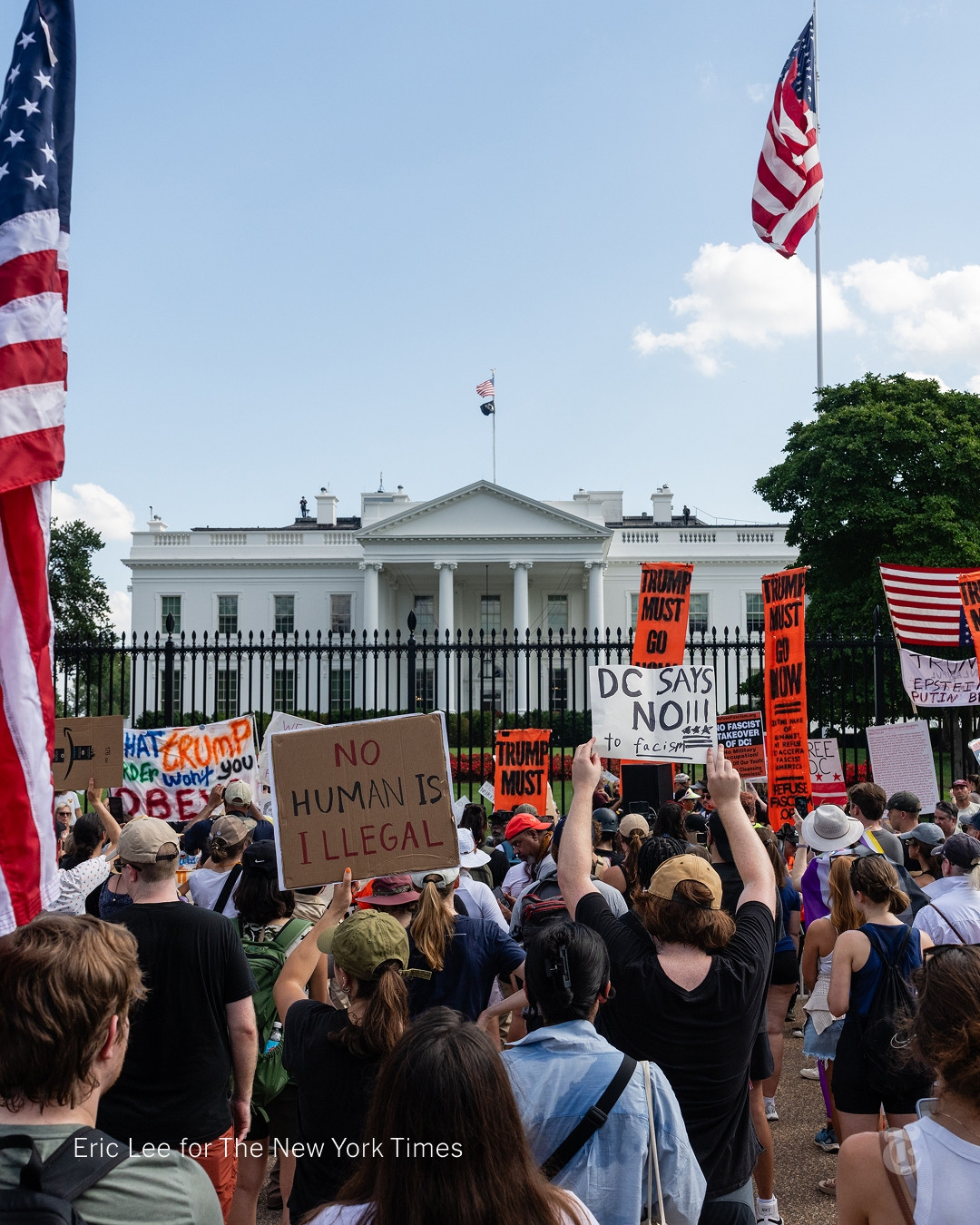 A large group of protesters in front of the White House. They are carrying signs that say things like "No Human Is Illegal" and "DC Says No To Facism!" Photo by Eric Lee for The New York Times