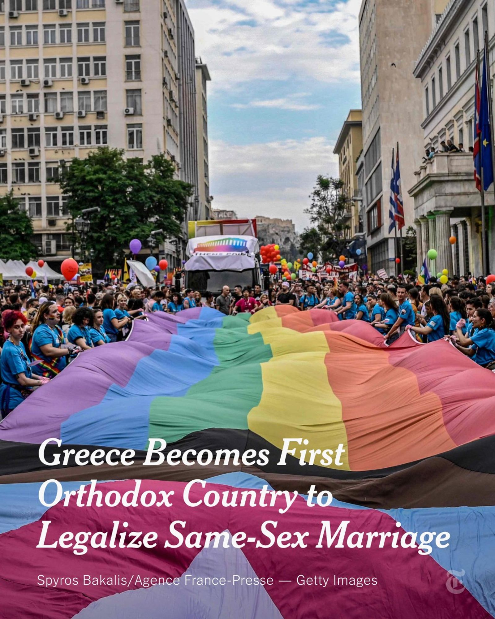 Lines of people wearing blue T-shirts carry a giant pride flag along an Athens street during a Pride parade last June as a crowd looks on. A headline reads: "Greece Becomes First Orthodox Country to Legalize Same-Sex Marriage". Photo by Spyros Bakalis/Agence France-Presse — Getty Images