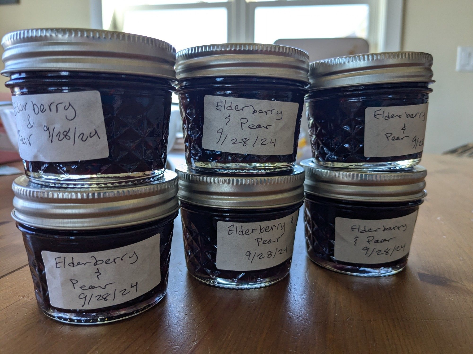 6 quarter pint jars full on dark purple elderberry pear jam