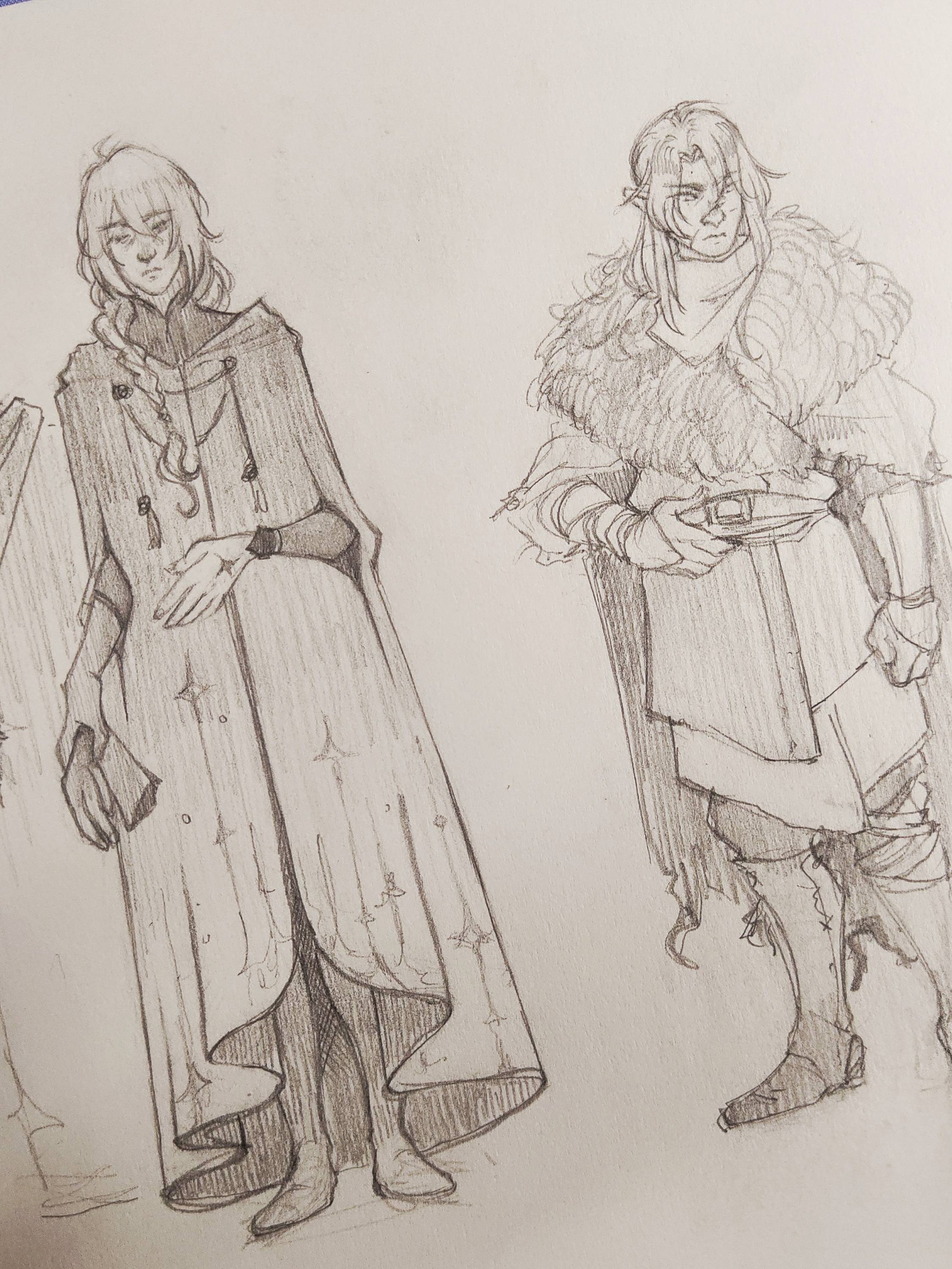 Drawing of two characters of a fantasy setting, both young men with long hair. The taller IS wearing a very long, royalty style cape with golden stars details, and the shorter one has elf ears, and wears a coat less sophisticated, with several layers of hand made clothes and leather.