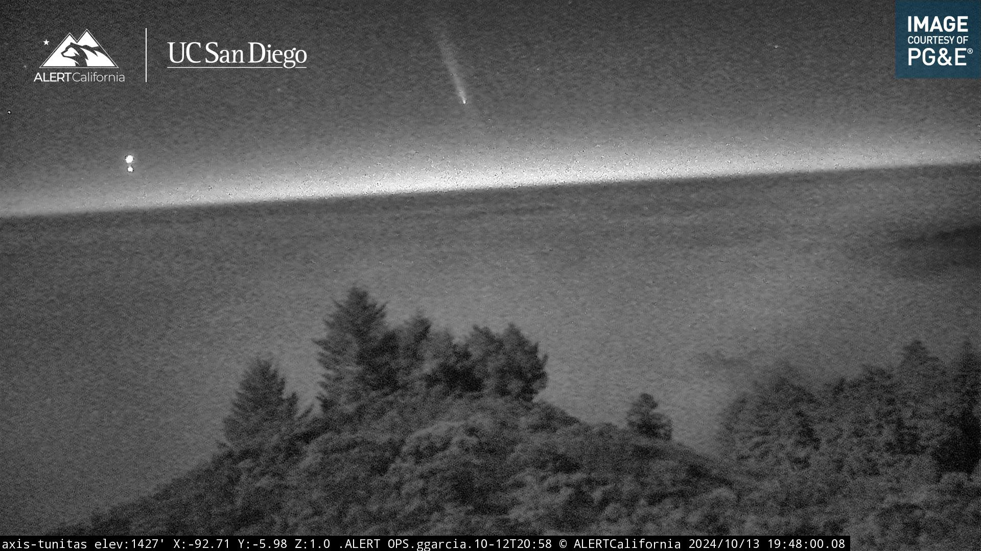 Pretty much what is says on the tin.

In this image you can see the comet much clearer above the central copse of trees. The bright dot to the left, near the horizon is Venus. 