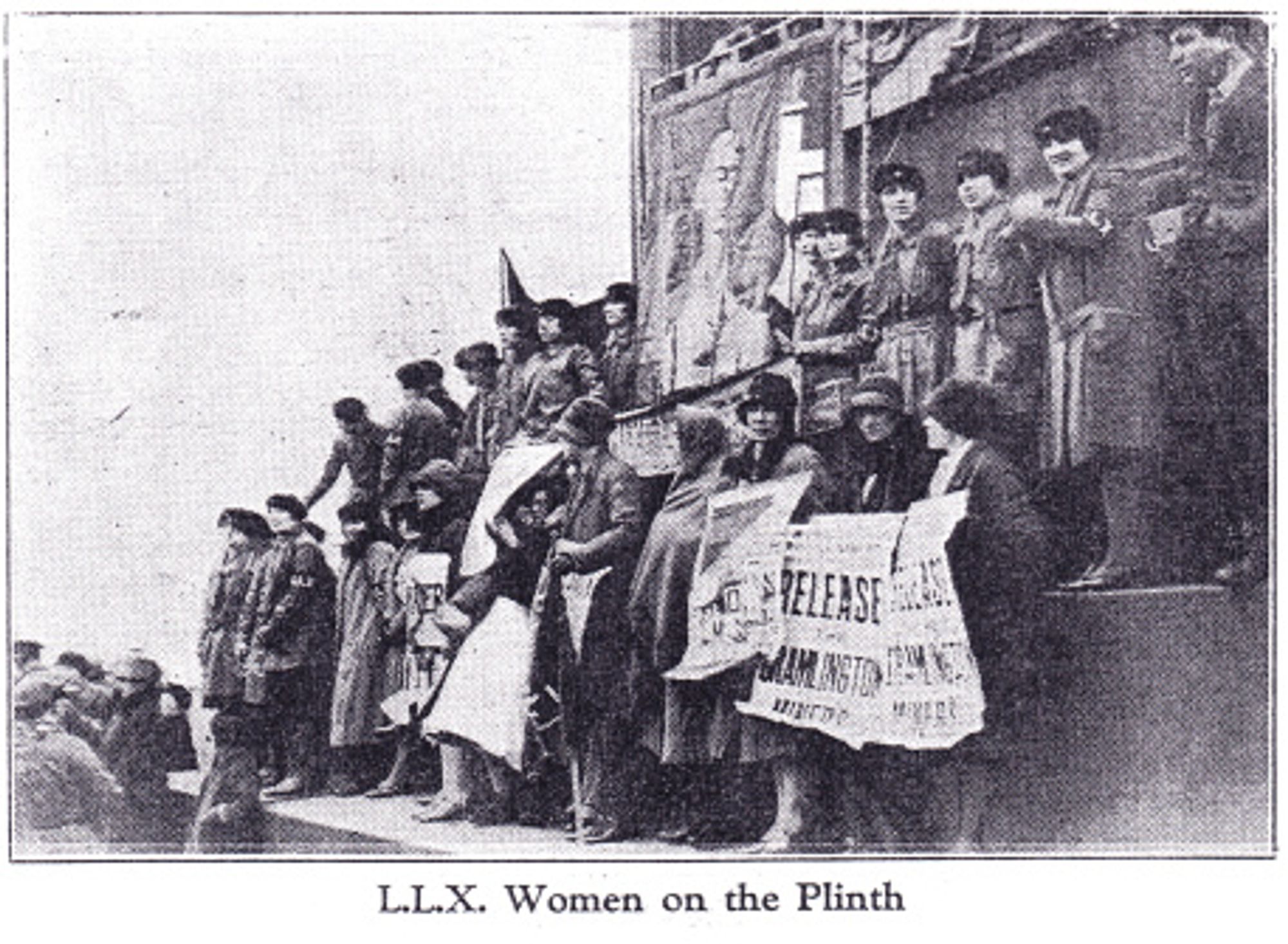 newspaper photo of women standing on the plinth at Trafalgar Square holding banners