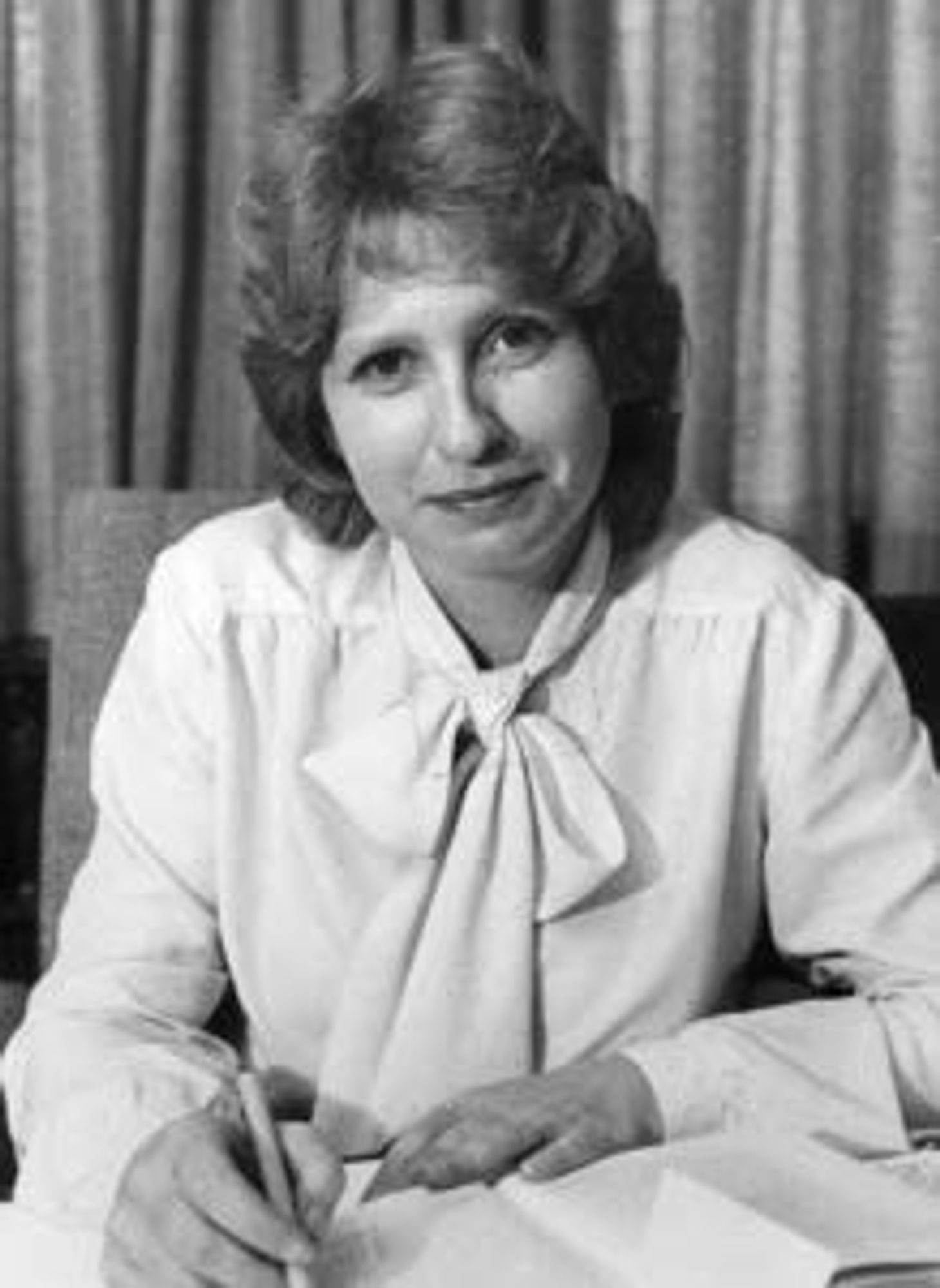 Mary Gaudron QC sat at a desk. She is a white woman with light hair in a very 1980s blowout.