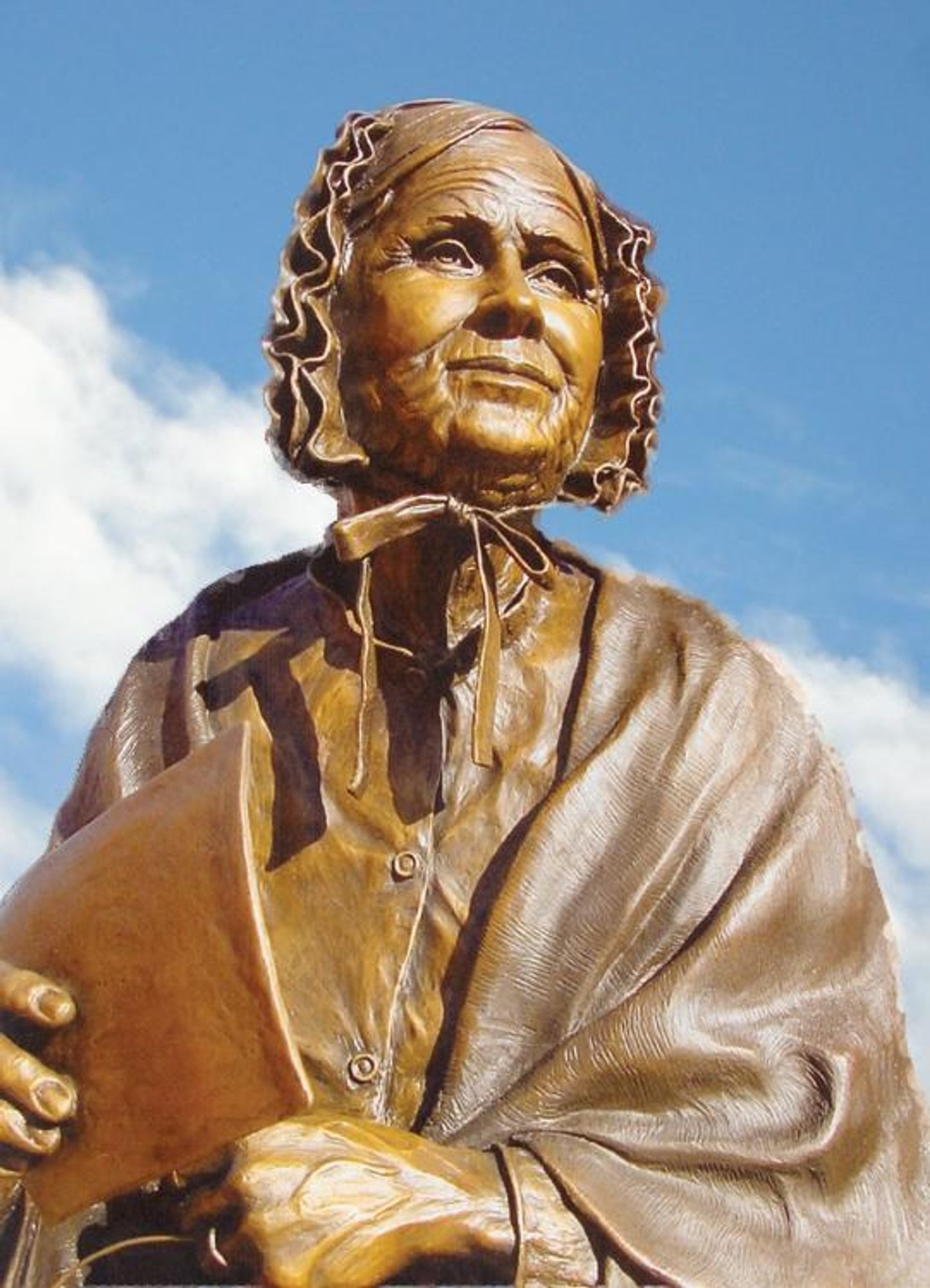 bronze statue of Louisa Ann Swain holding a ballot paper