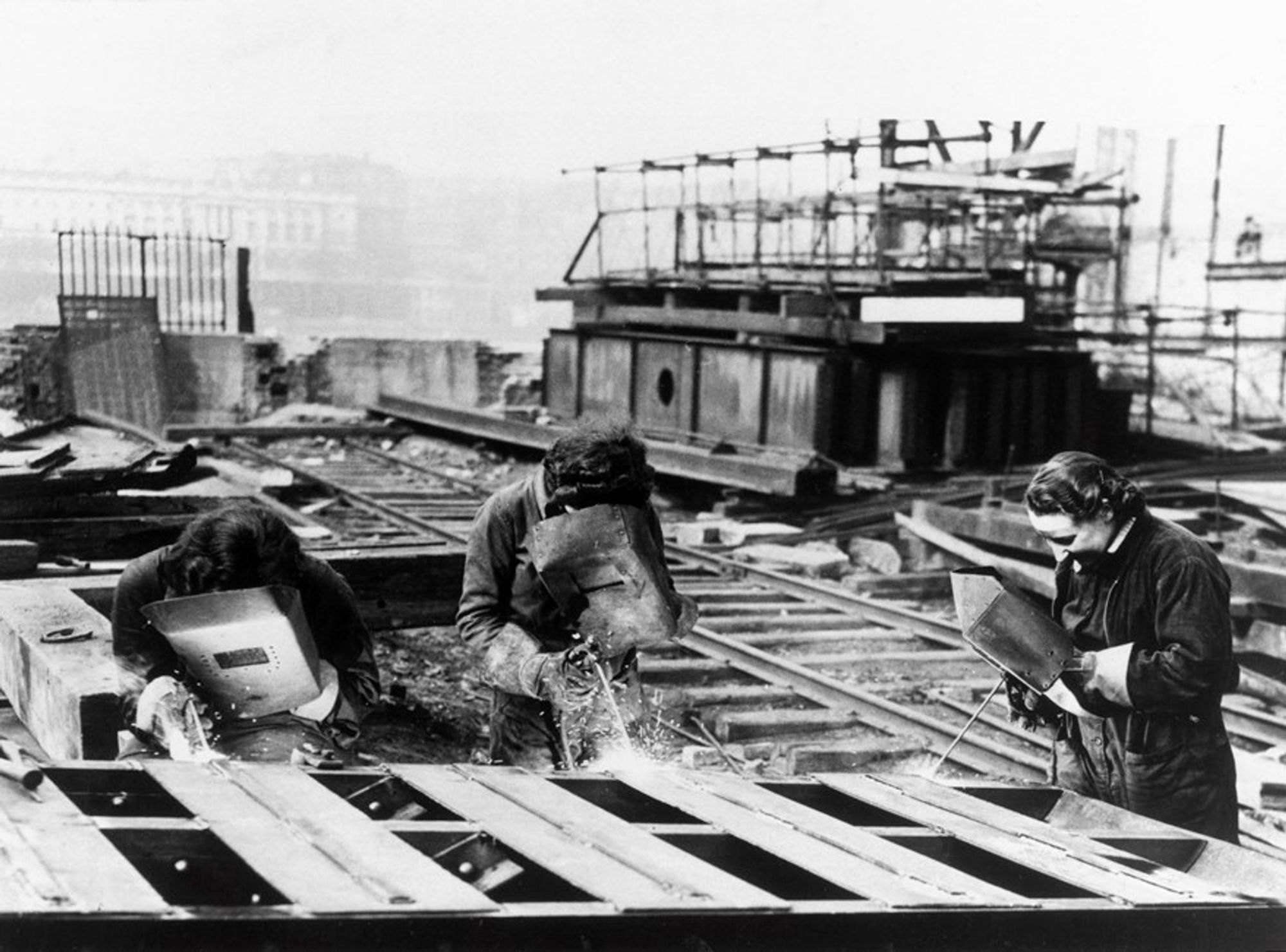 Three women acetylene welders cutting the girders of the temporary Waterloo Bridge