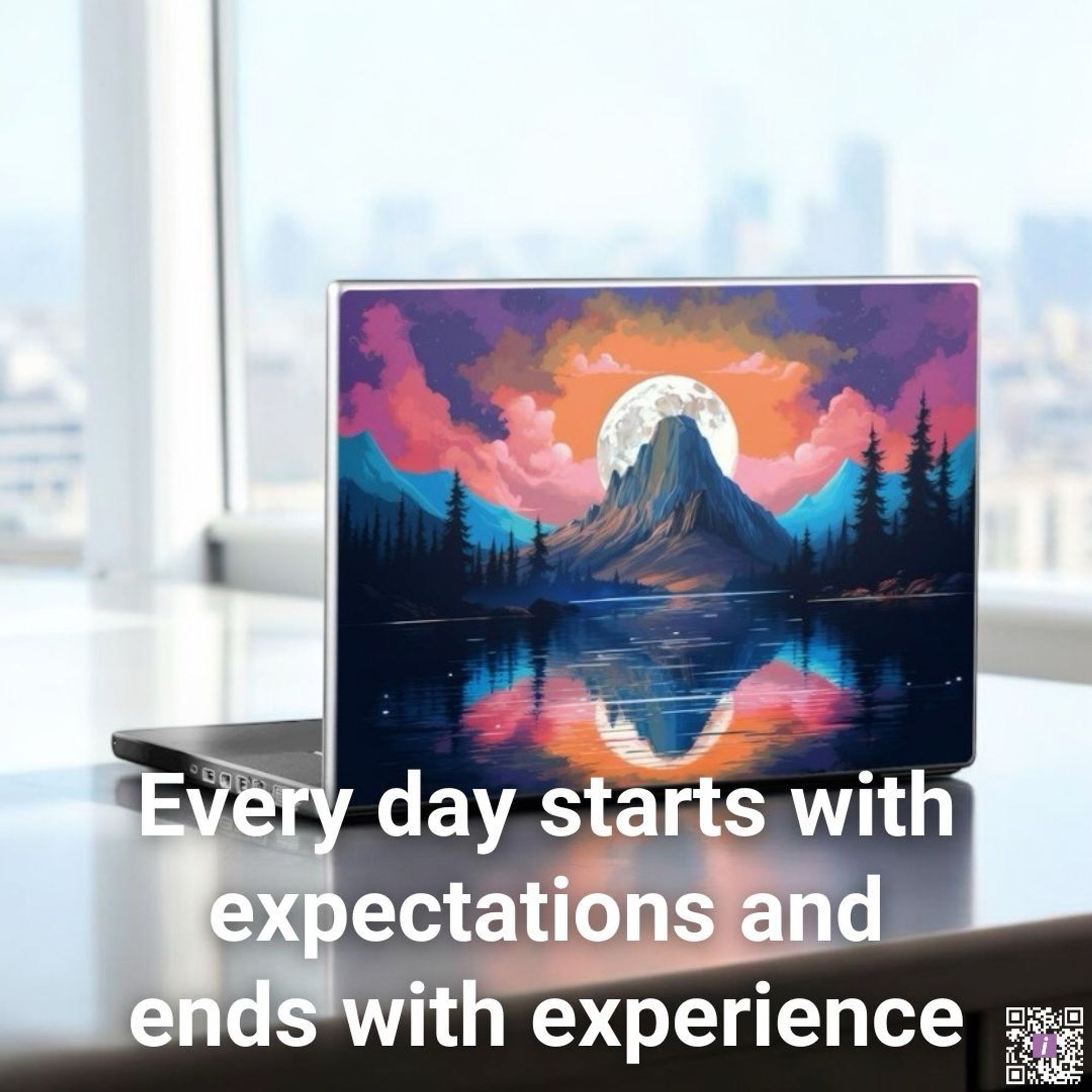 Laptop styled with a majestic painting of the moon rising against a mountain