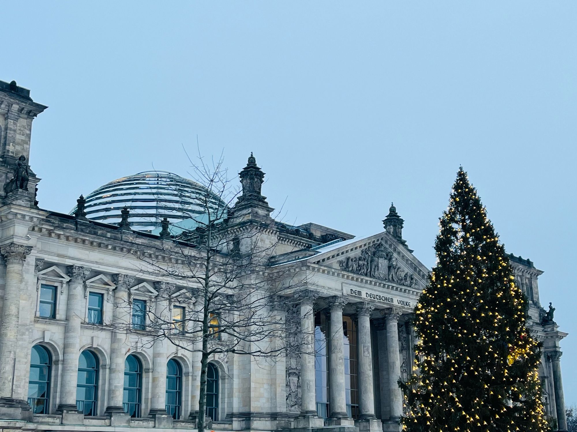 German Reichstag building with a Christmas tree in front.