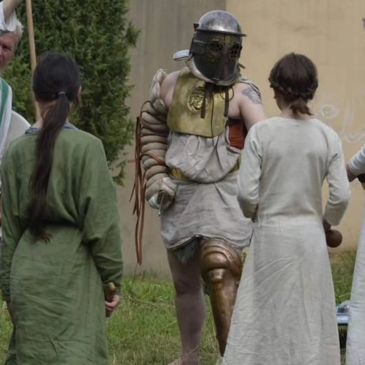 Gladiator explaining fighting techniques to two girls