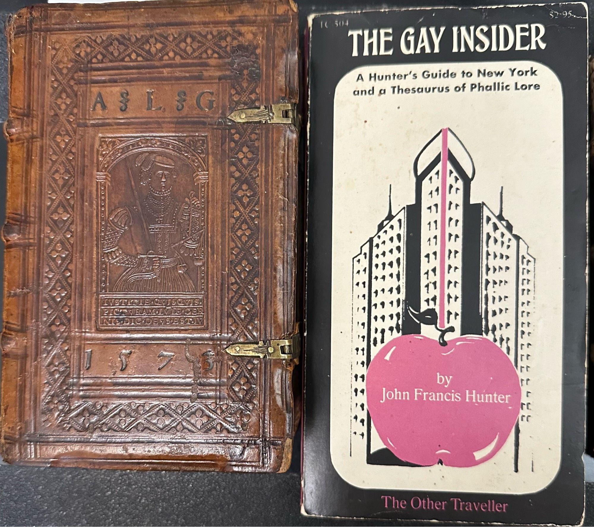 1573 clasped binding next to a 1970 phallic paperback cover of the Flatiron Building.