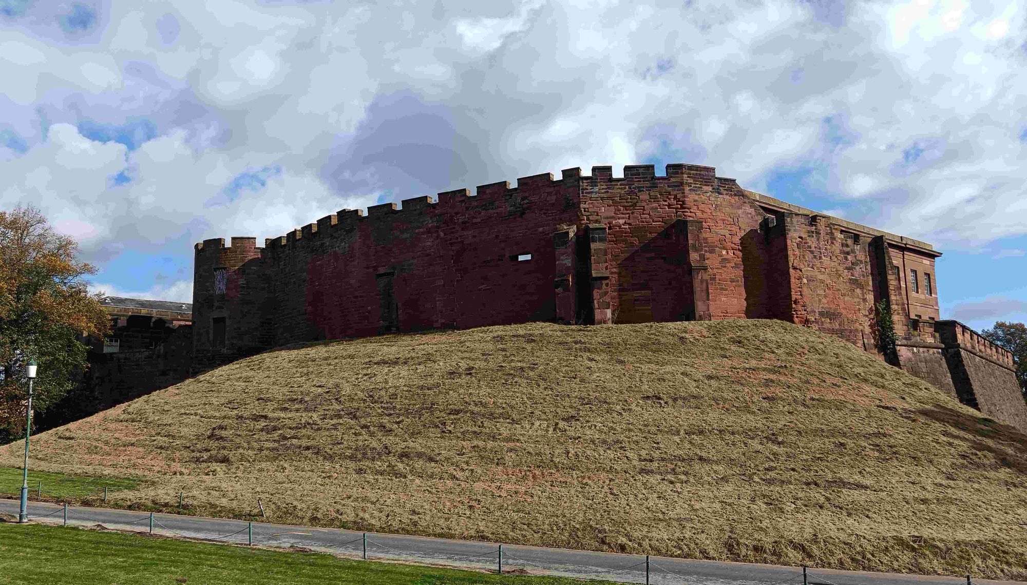 Red stone fortifications stop an earth mound.