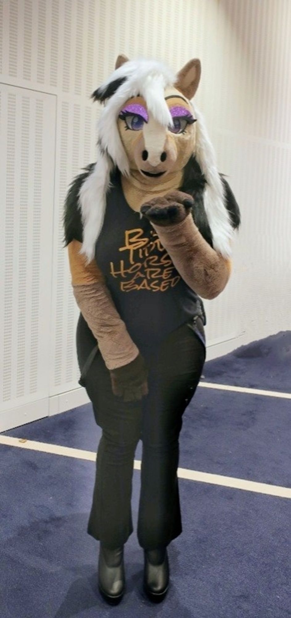 Horse Fursuit looking at the camera blowing a kiss