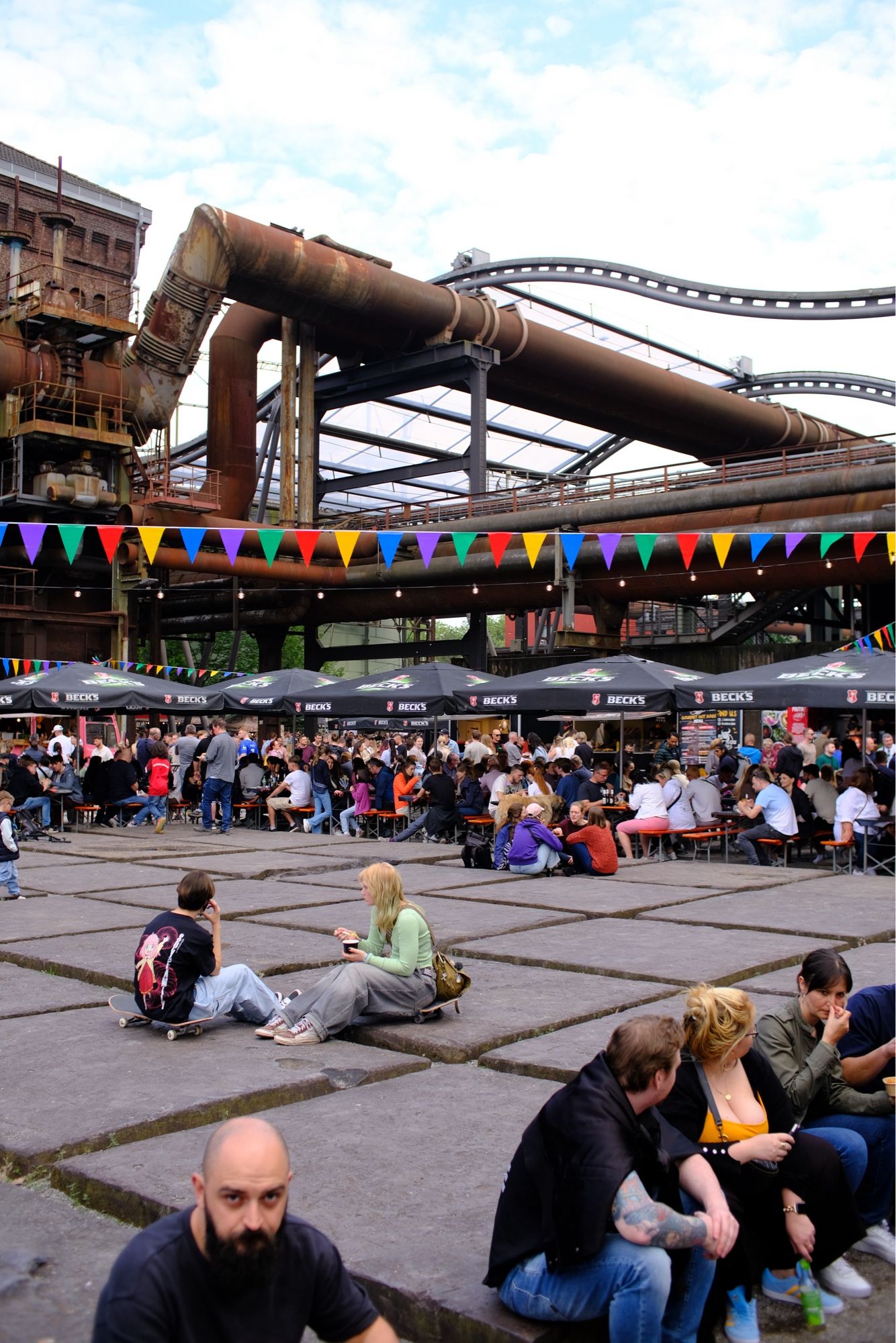 People eating in a food festival with historical industry background