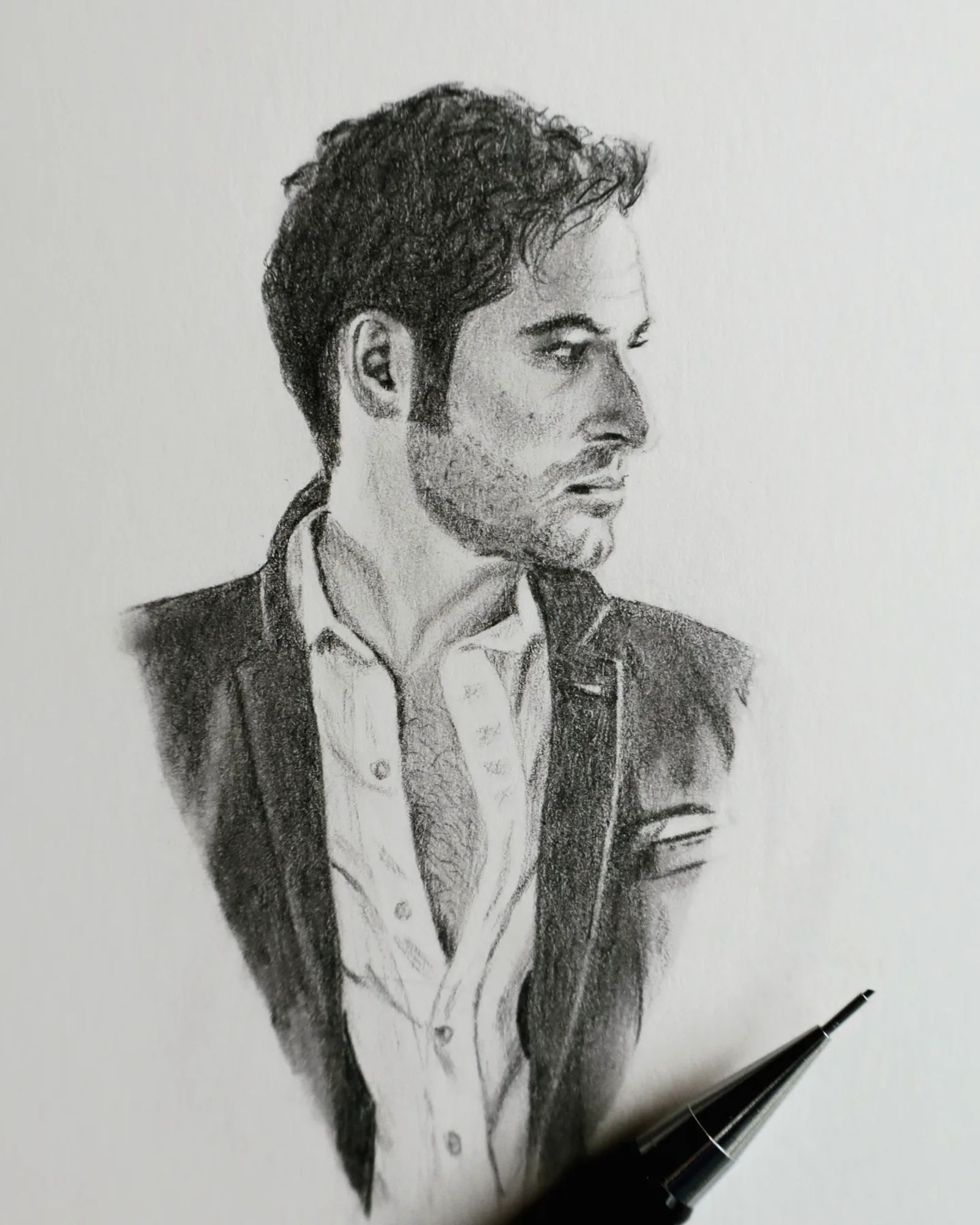 Pencil drawing, with a pencil laid across the bottom of the photographed page to indicate its small scale. Head and shoulders of a dishevelled Lucifer, shirt, jacket and hair all askew. He looks off to the right.