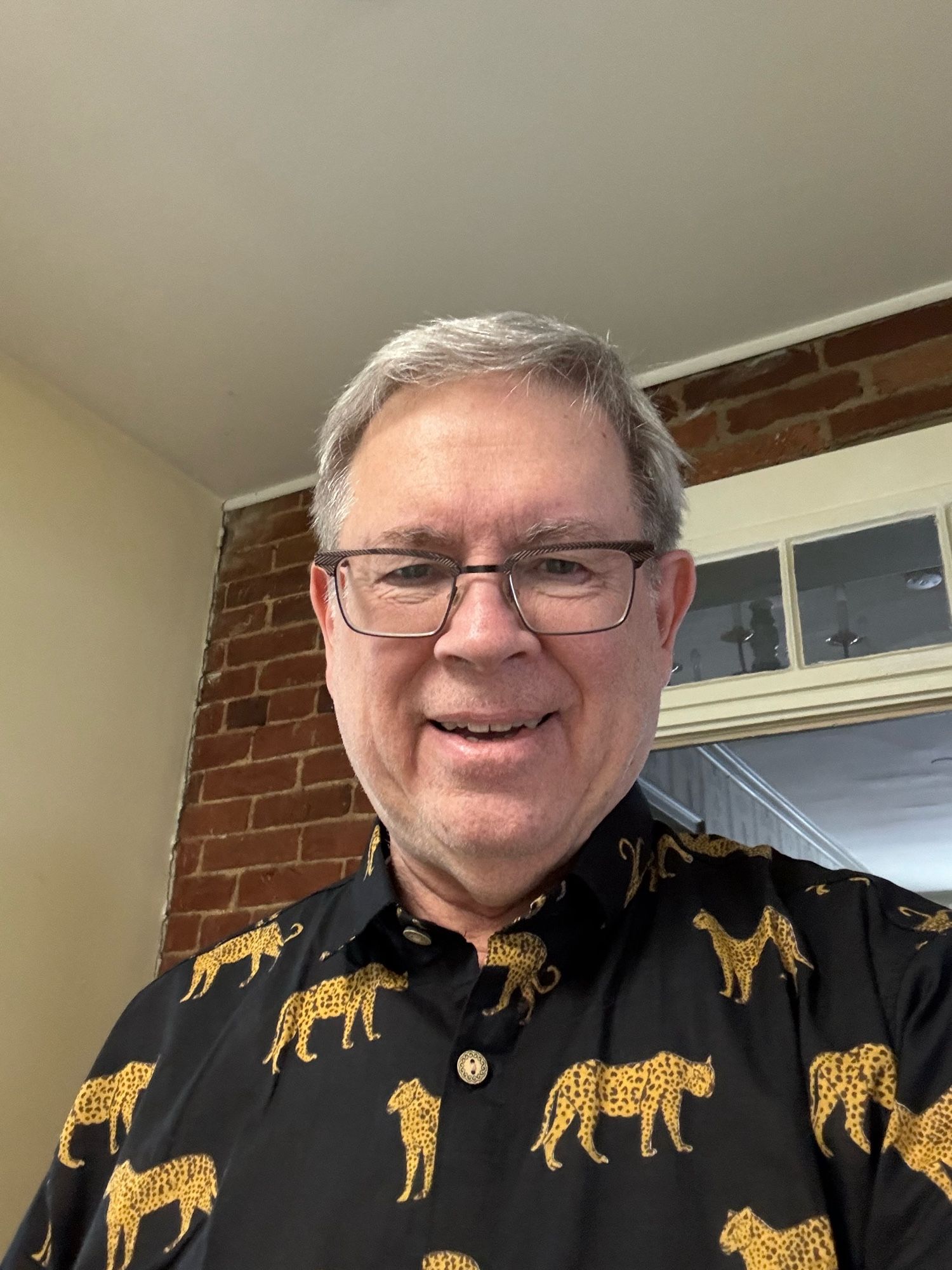 Olson wearing black and gold cotton shirt with spotted jungle cats.