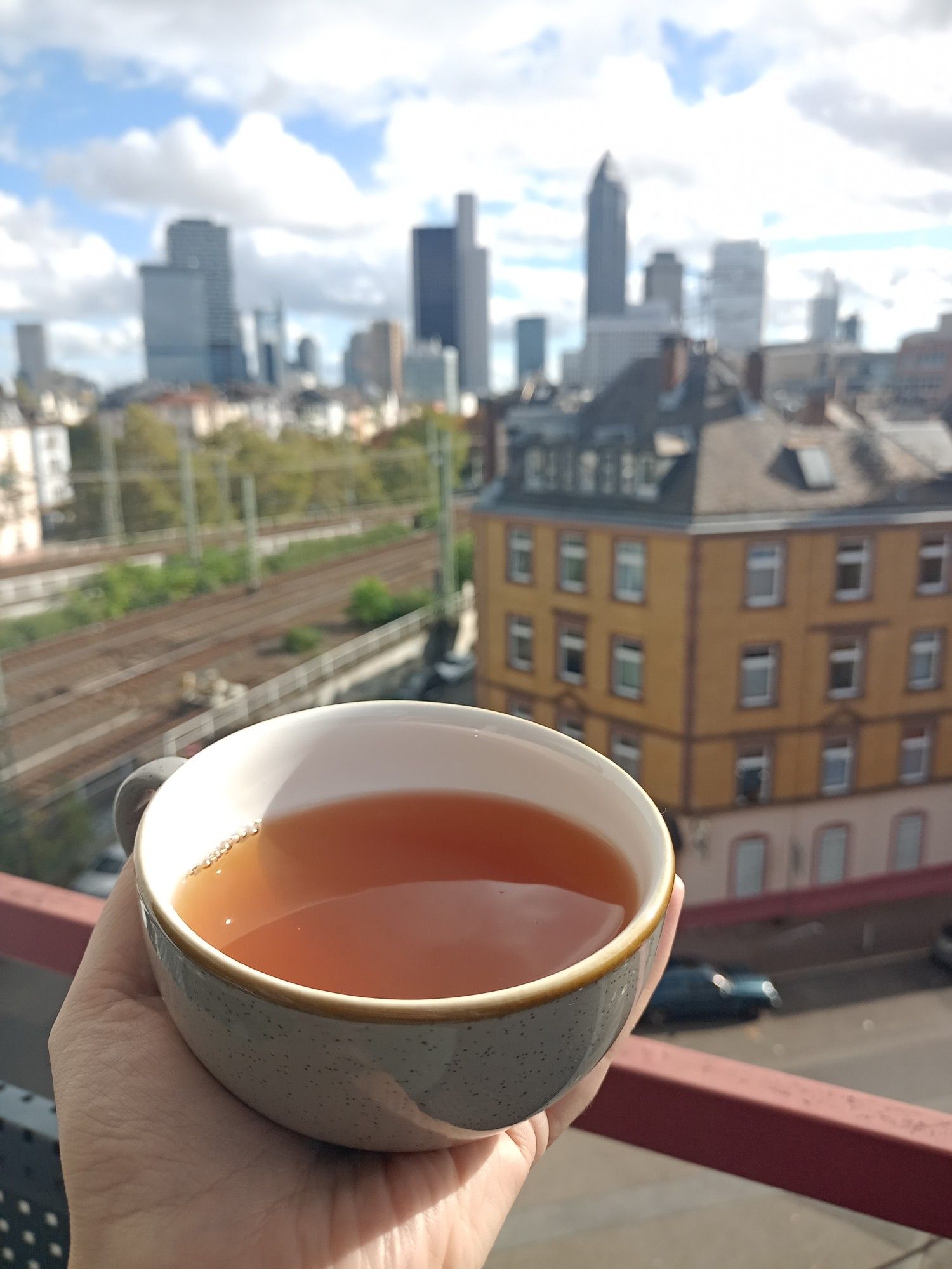 Cup of tea in front of the blurred Frankfurt Skyline. Sunny October day during the Book fair. The big quiet before the next storm.