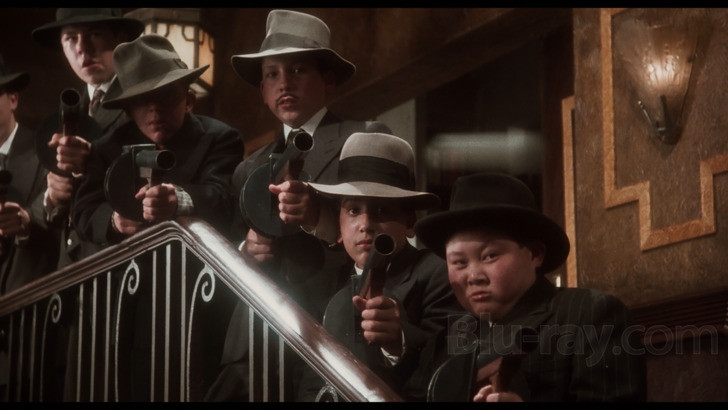 Middle school aged kids pointing firearms at the camera, a still from Bugsy Malone