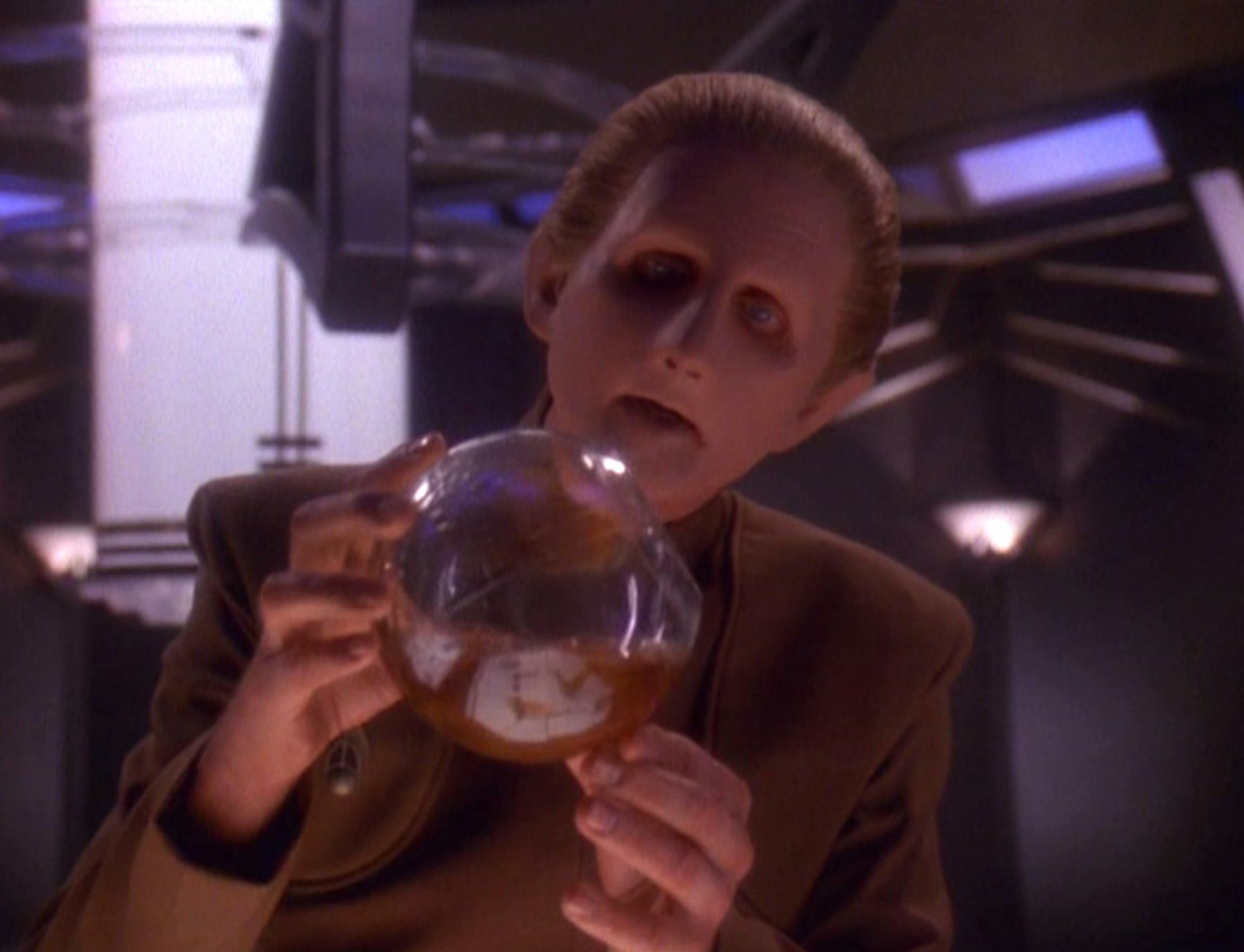 Odo looking into a ball of goo, another Changeling.