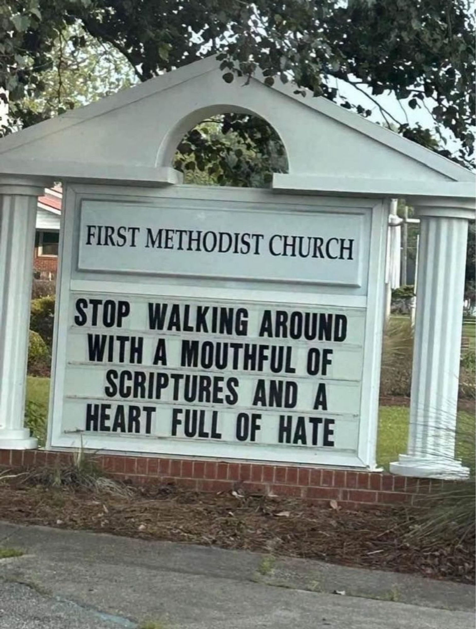 The reader board in front of First Methodist Church which reads: stop walking around with a mouthful of scriptures and a heart full of hate.