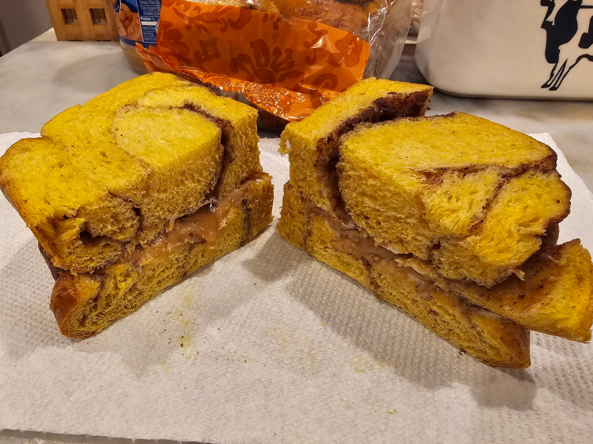 Thick sliced brioche with a cinnamon swirl made into a peanut butter sandwich and sliced in half