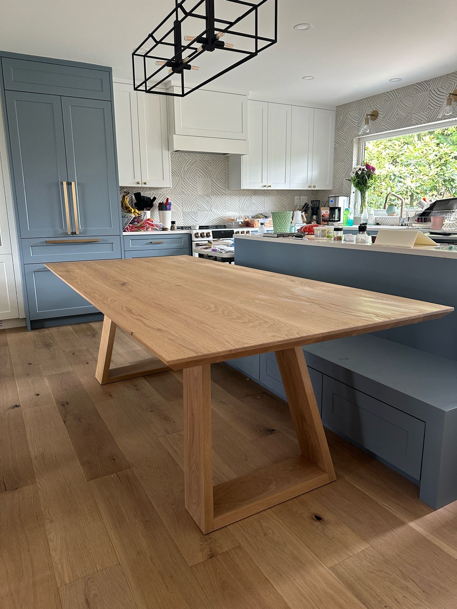 A white oak table, in a modern kitchen.