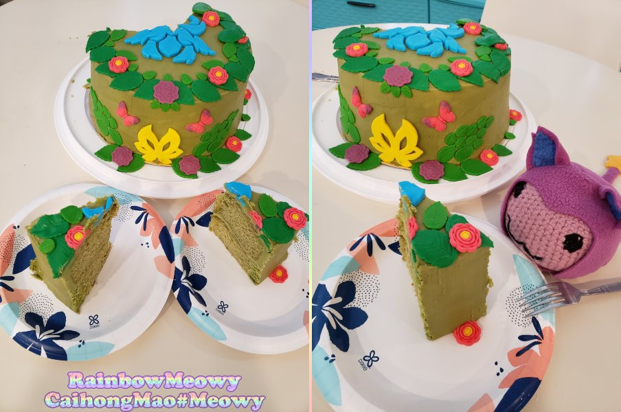 My cooking contest cake with some slices cut and plated. Green match + matcha buttercream cake with colorful fondant flowers, TFT Faerie emblem, TFT Lillia augment icon. A purple poring (crochet plush) in a dango costume (sewn fleece) is near the plate looking hungrily.