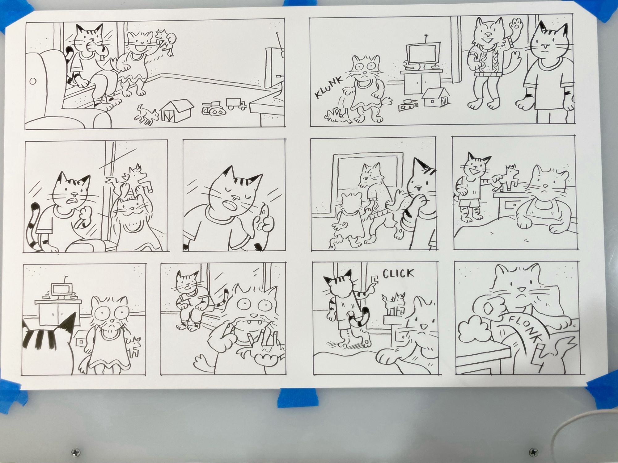 photo of two comic pages on a lightbox, black ink line drawings on paper. in the panels some anthropomorphic cats appear to be talking about a toy horse.