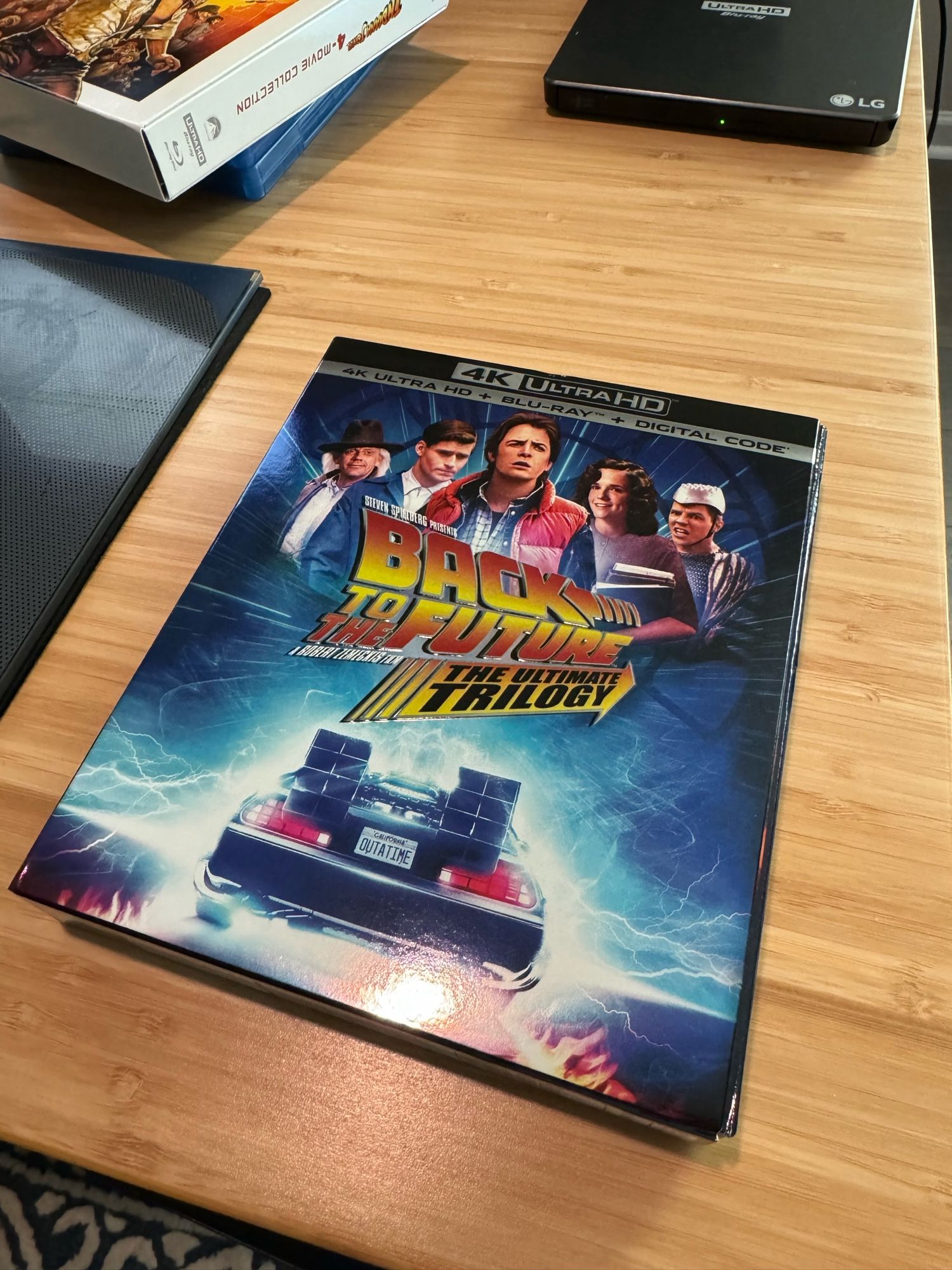 The cover is a glossy shot of the delorean with the outtatime license plate shown.