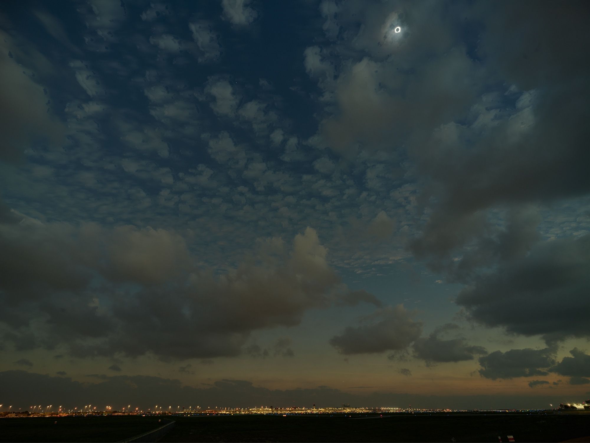 Total eclipse over a dark airport