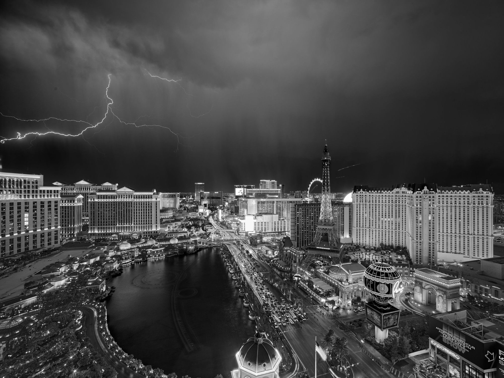 Las Vegas Strip at night, with lightning in the sky.