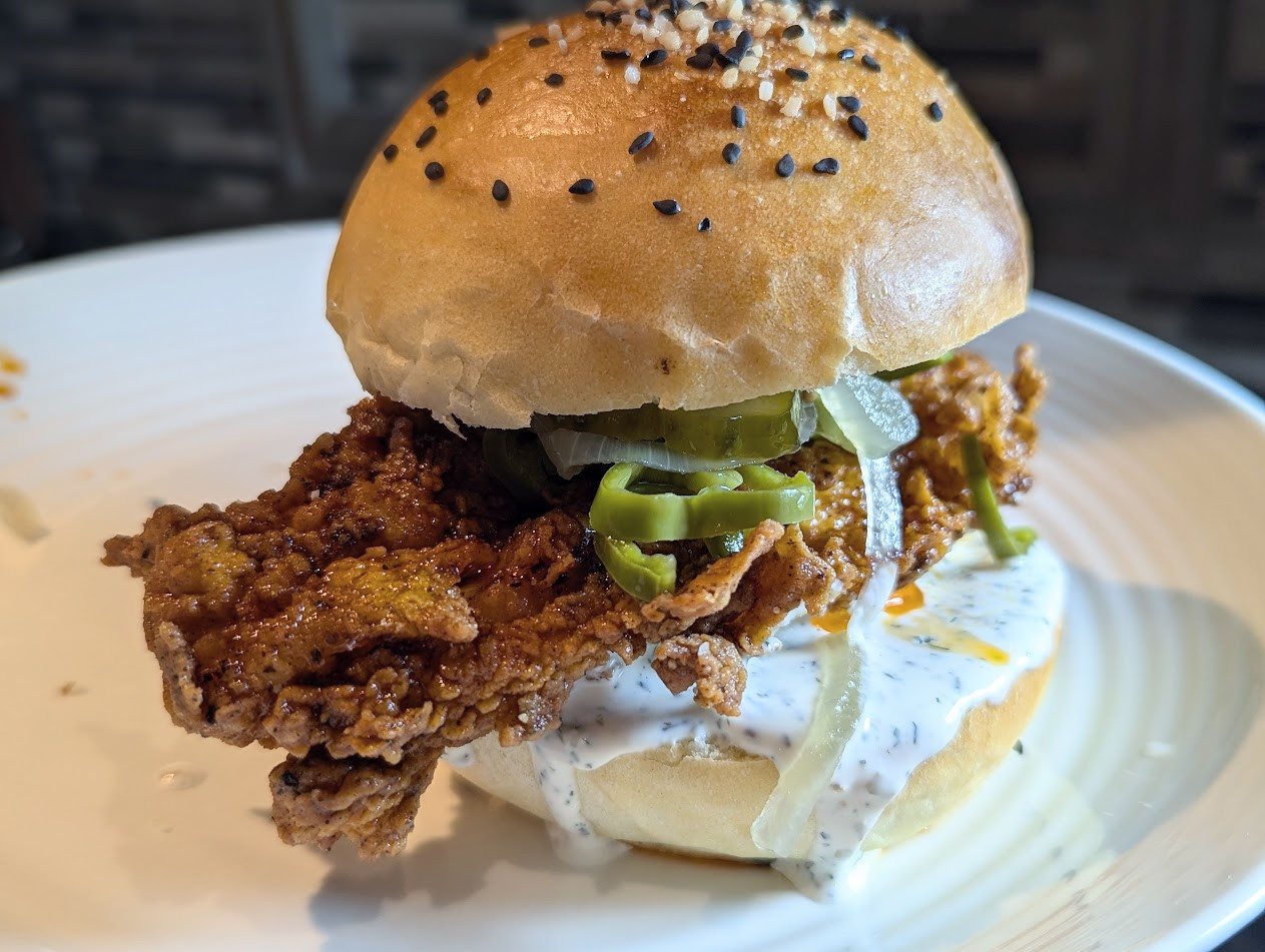 Buttermilk Fried chicken on a fresh homemade bun with quick pickled anaheim peppers and homemade buttermilk ranch dressing.