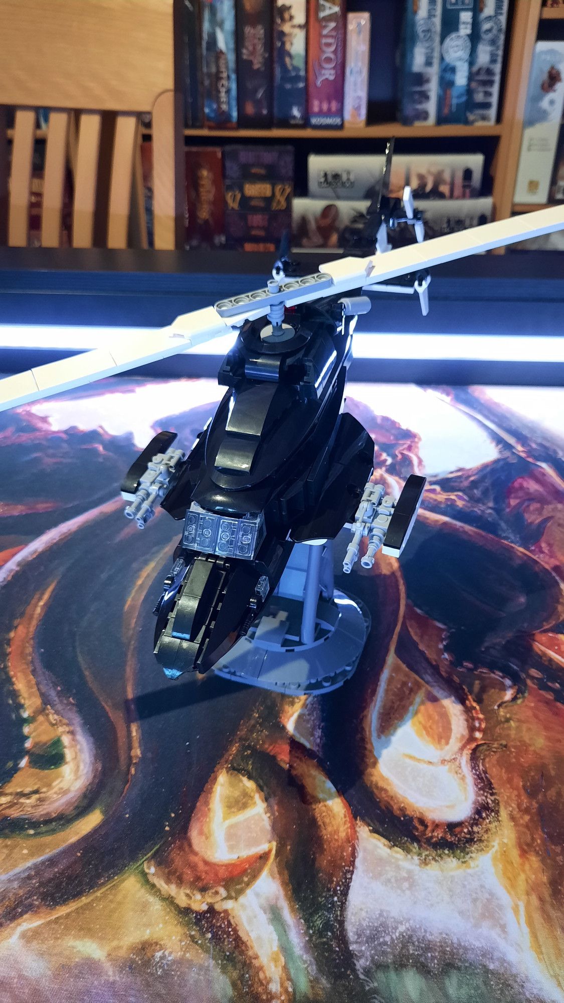 A finished brick set showing a black helicopter with the white bottom shining through at some places. The helicopter is shown from the front side.