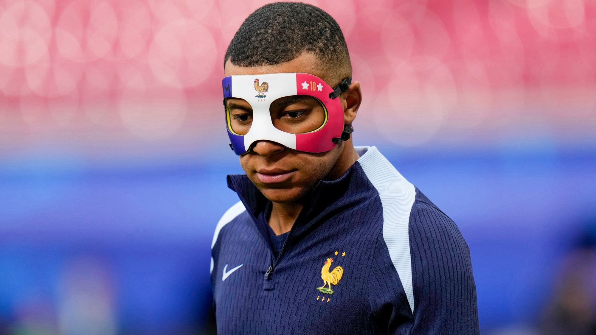 Mbappe wearing a mask during training.