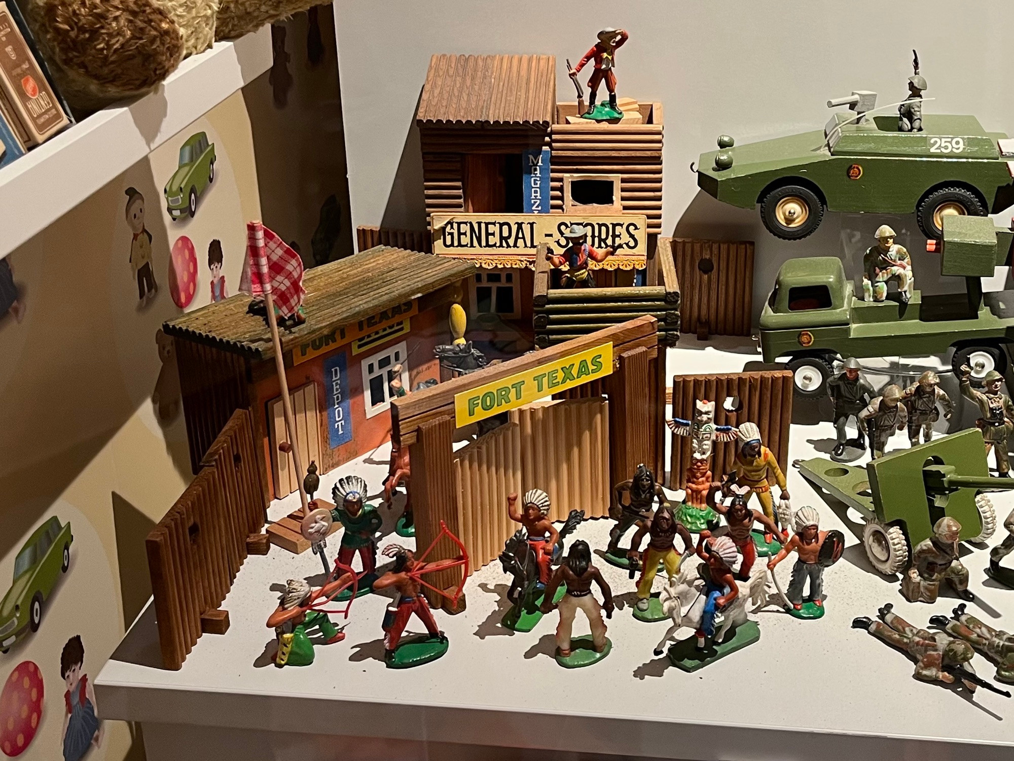 A wooden toy fort with "Indians" and "Cowboys".