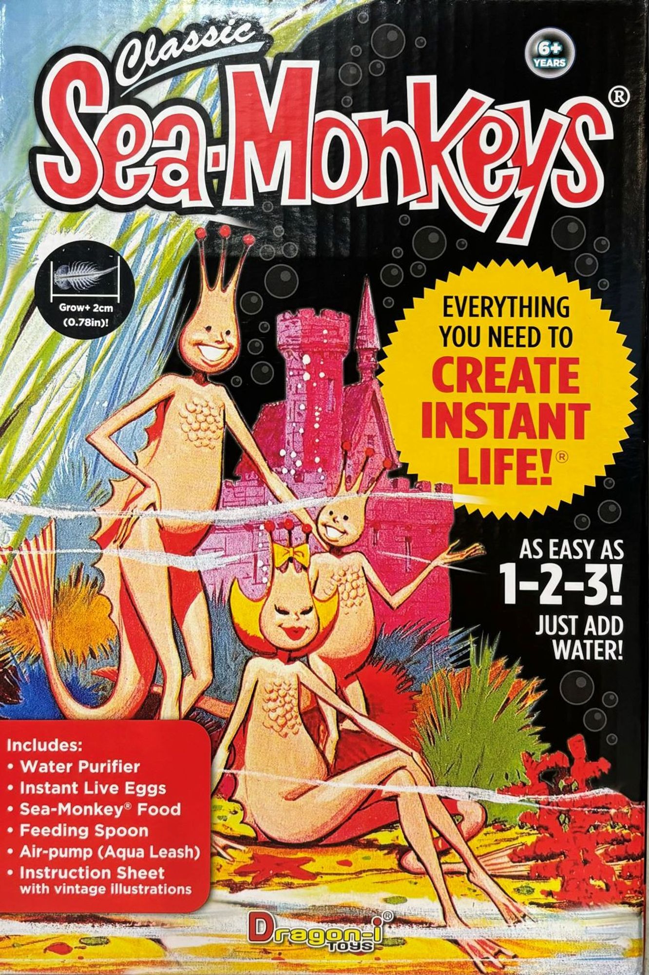 Classic Sea Monkey packaging. Shows family of 3 sea monkeys hanging out in front of a pink castle.