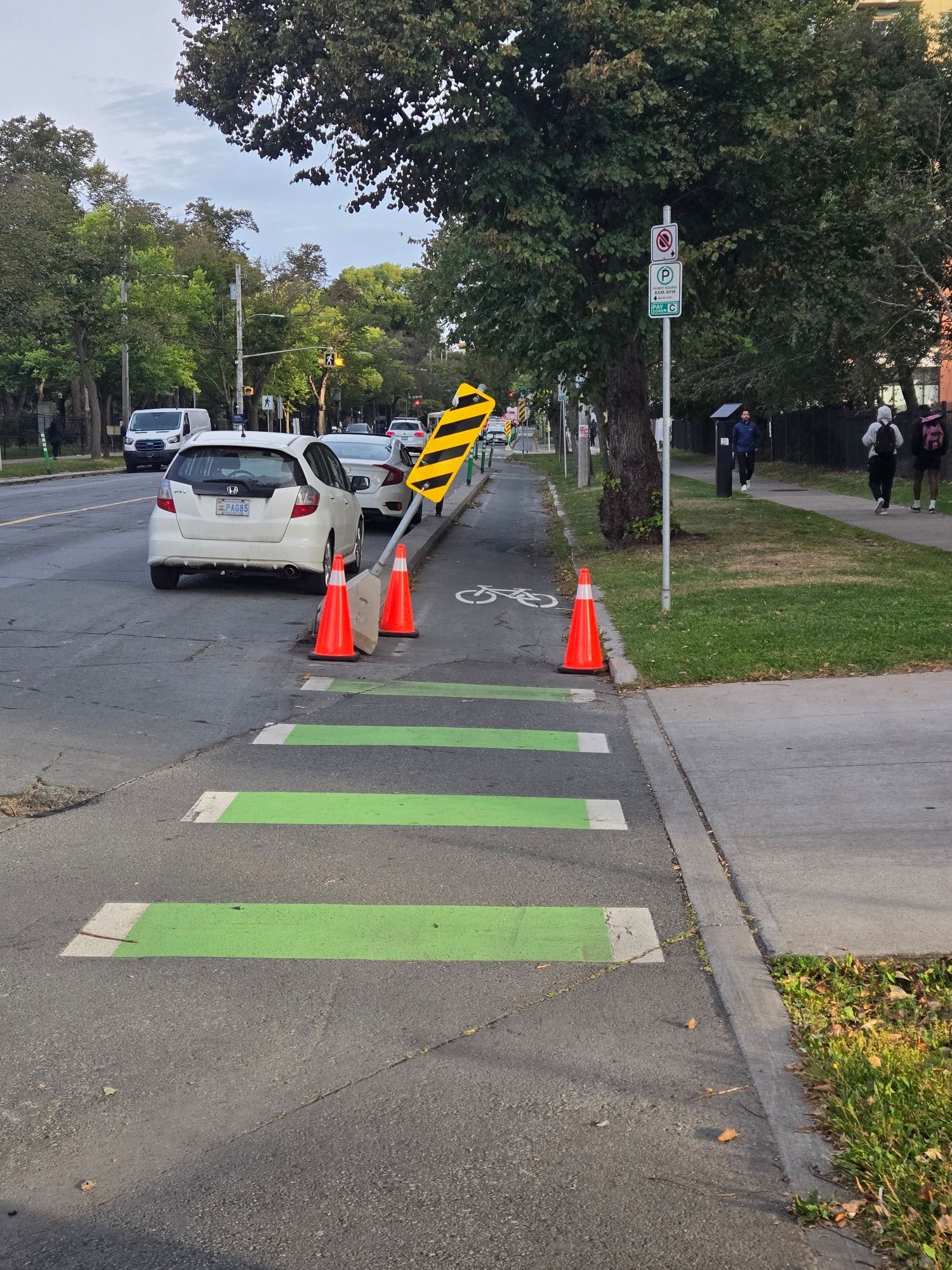 Sign partially blocking a bike lane.