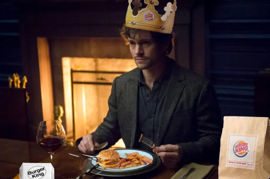 A scene of Will Graham from the show Hannibal that has been edited to give Will a Burger King crown and meal.