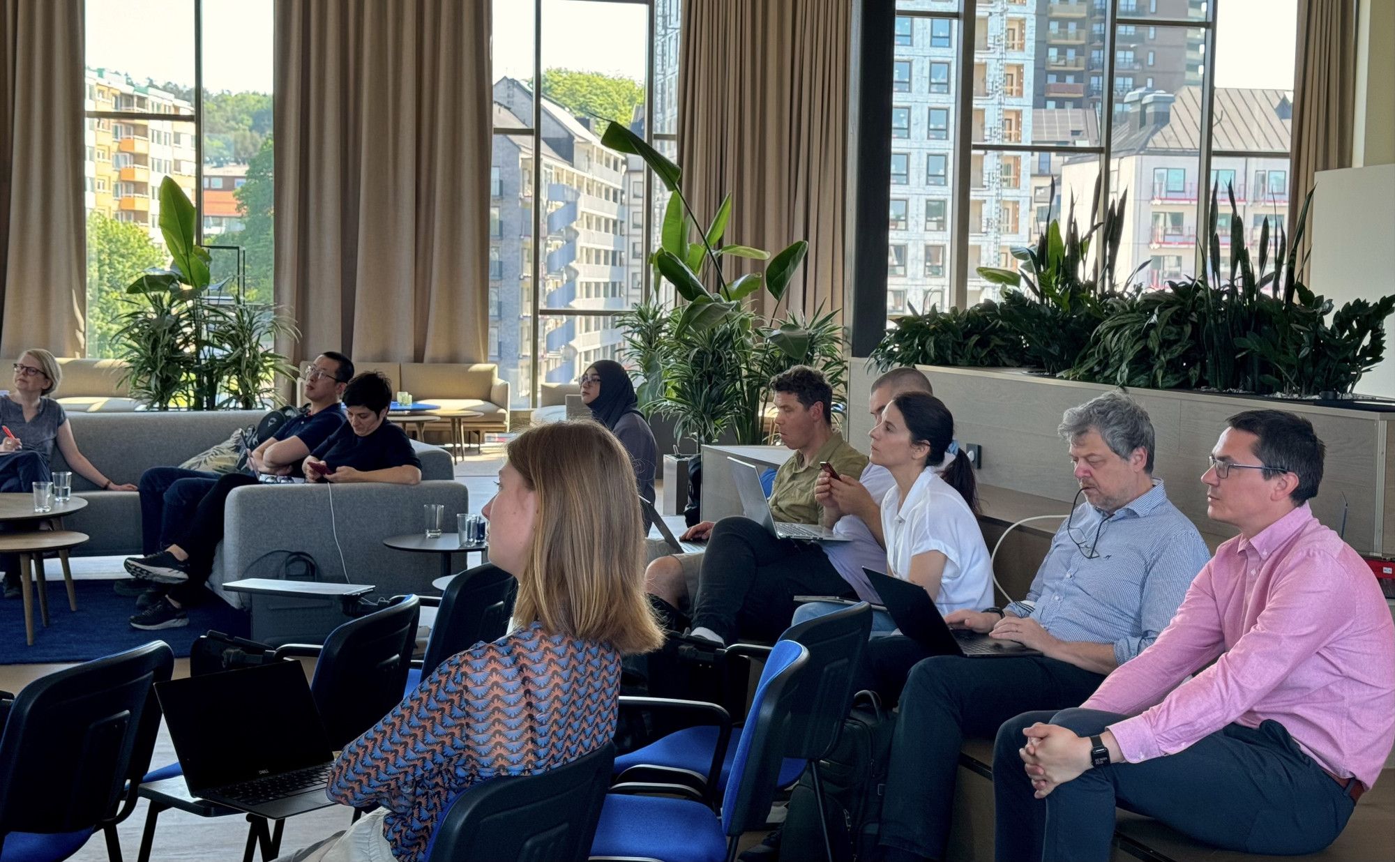 People sitting in a conference room listening to a presentation.