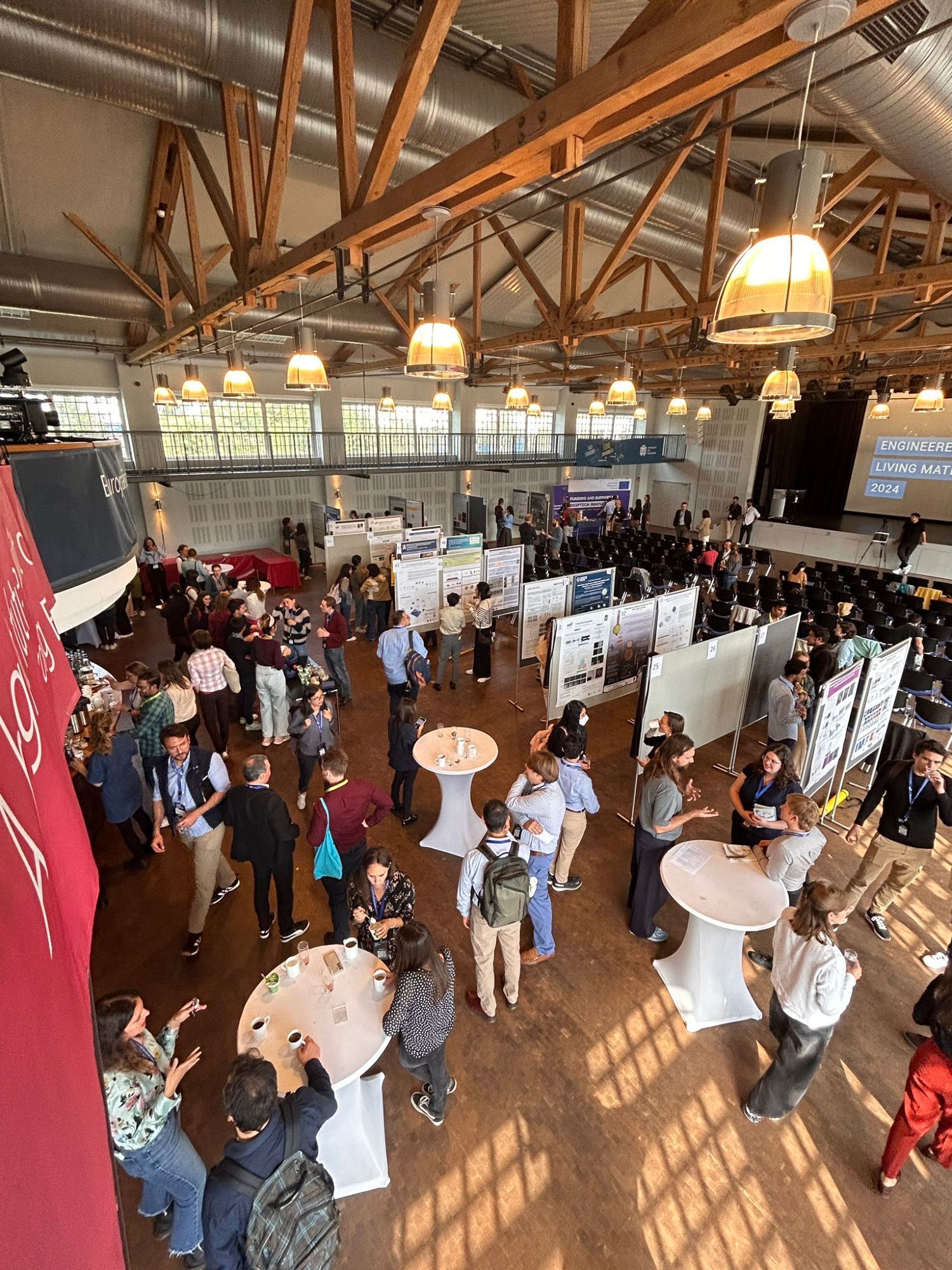 People walking around a poster session at a conference.