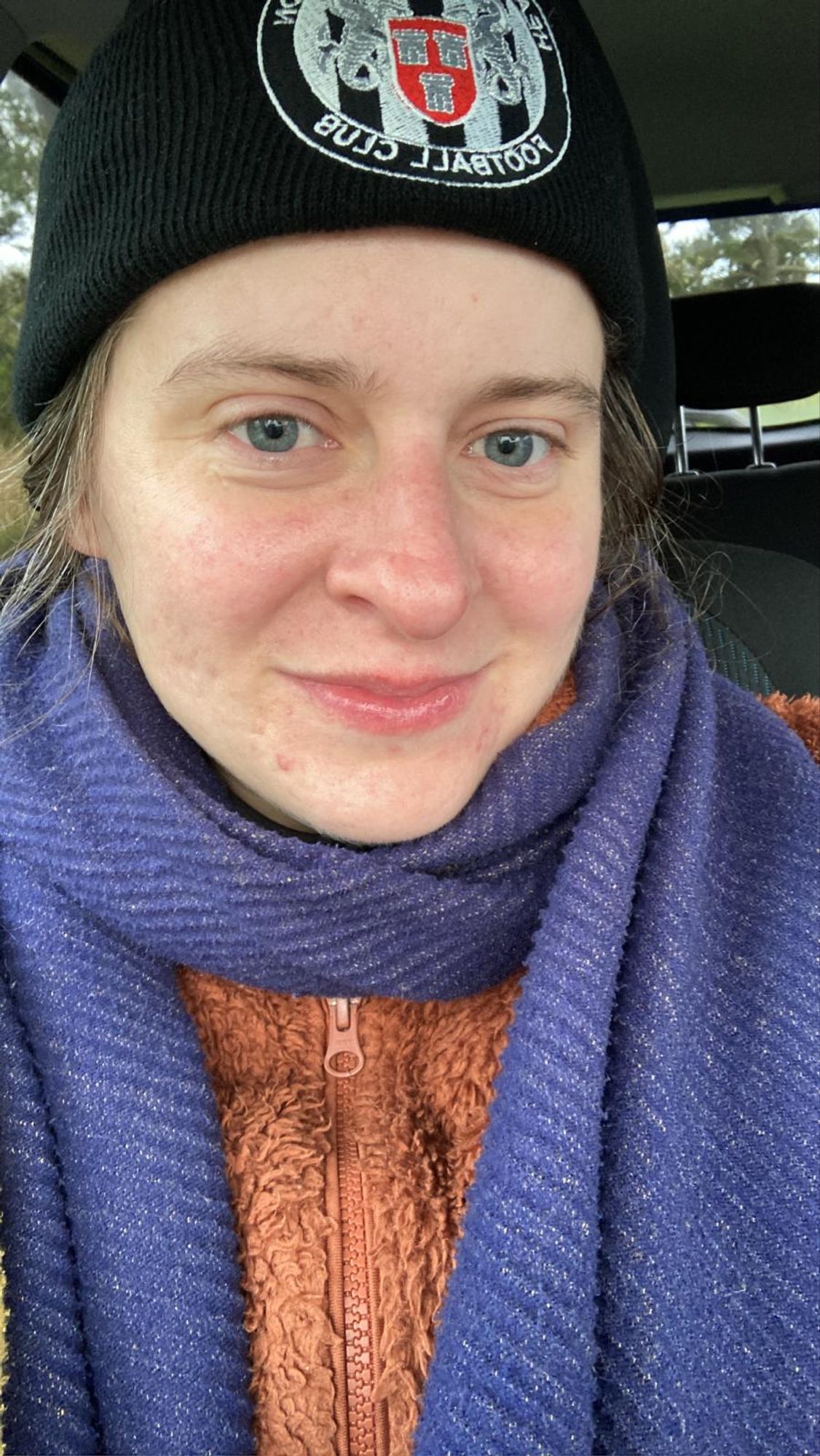 Me wrapped in lots of layers, a big blue scarf, an orange zip-up fleece and a black Heaton Stannington Football Club beanie, after having been in the north seat at 7am this morning