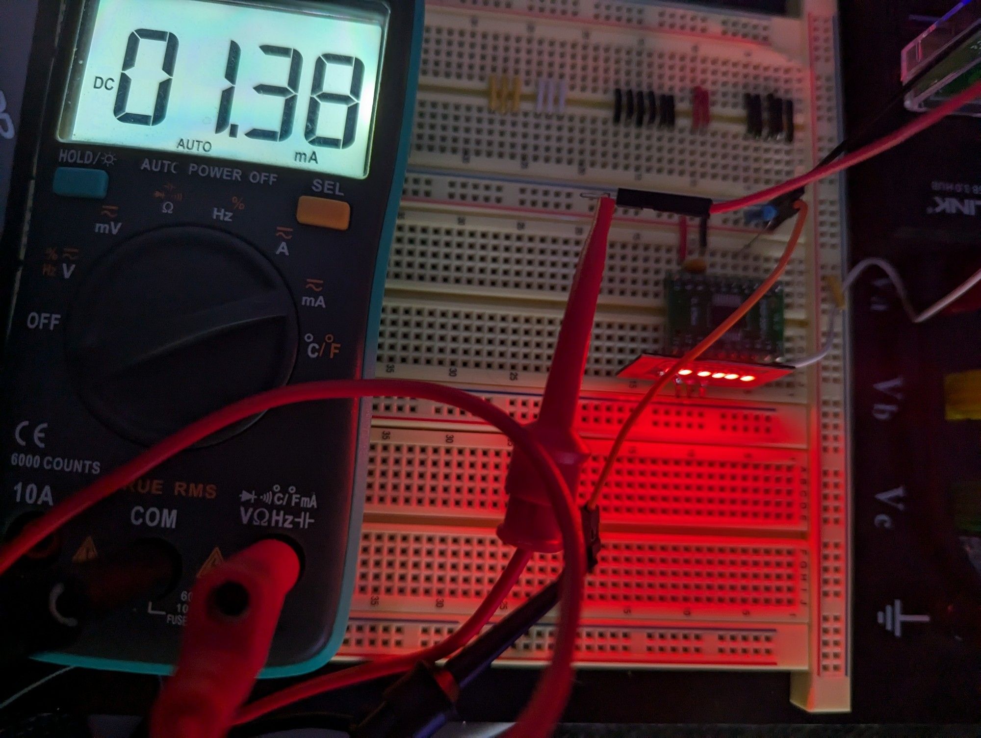 A multimeter measuring the current draw of a ch32v003 microcontroller.