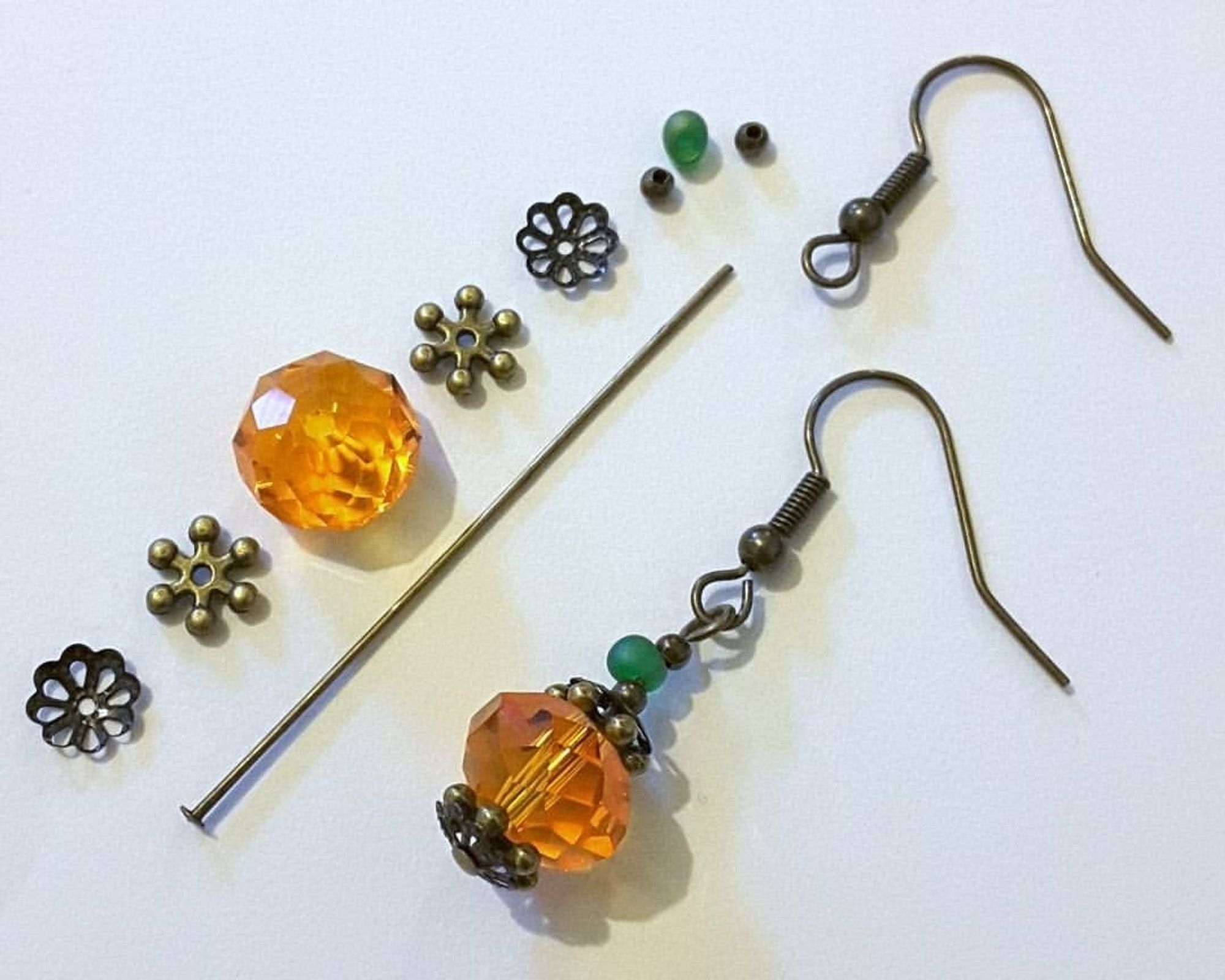 ~ How To Make Pumpkin Earrings ~ 
You Will Need : 
10x12mm crystal rondelle beads x 2, 6mm filigree bead caps x 4, snowflake spacer beads x 4, 3mm metal spacer beads x 4, 3.4m miyuki drop beads x 2, 50mm head pins x 2 and the earring wires of your choice. 
Instructions : 
1. Slide beads on to the head pins in the order shown. With jewellery wire cutters, trim each pin leaving 1cm of spare wire above the final bead.
2.  Turn a loop at the top of each head pin with round nose pliers. 
3. Add your earring wires using chain nose pliers.
Options : 
Substitute pressed glass druk beads for the miyuki drops. 
Substitute pressed glass druk beads for the crystal rondelle beads. 
This design is infinitely customisable!